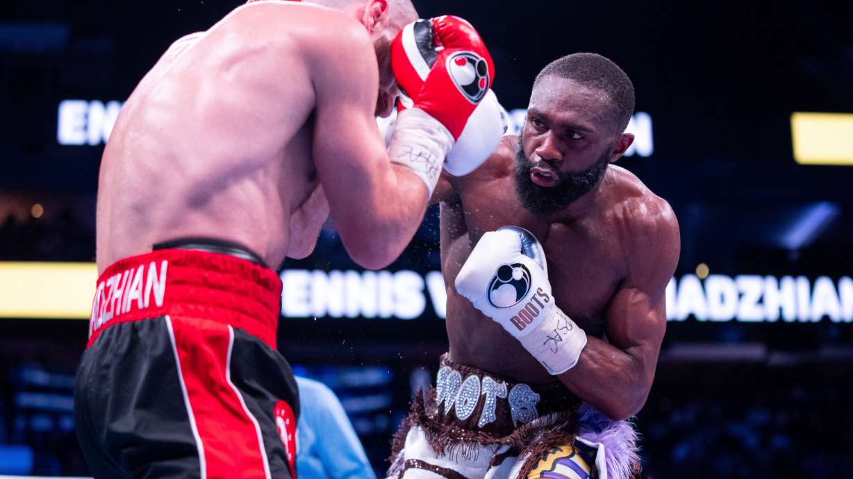 FILE - Jaron Ennis, right, throws a punch at Karen Chukhadzhian, left, during the ninth round IBF World Welterweight title bout, Nov. 9, 2024, in Philadelphia.