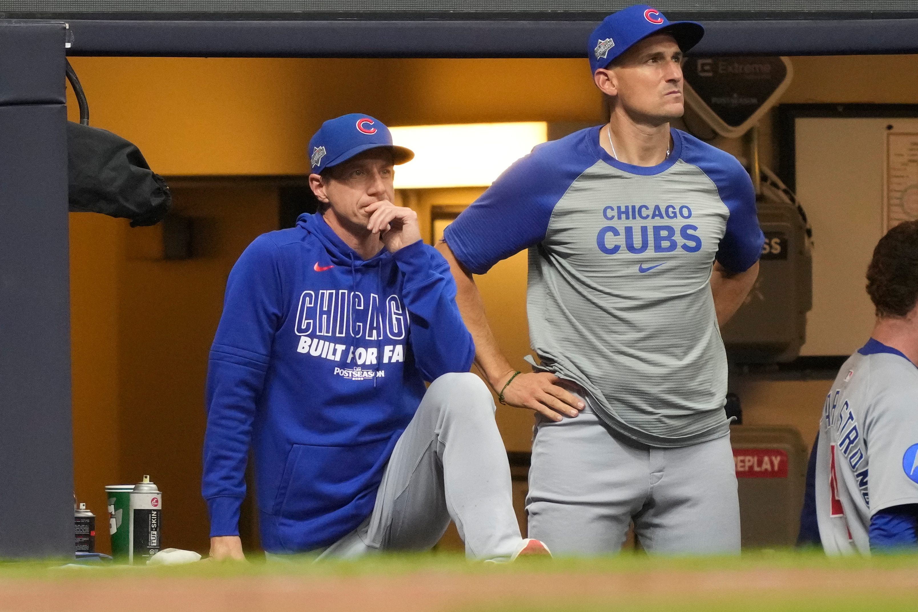Chicago Cubs manager Craig Counsell, left, and bench coach Ryan Flaherty, right, look on from the dugout during the seventh inning of Game 5 of baseball's National League Division Series against the Milwaukee Brewers, Saturday, Oct. 11, 2025, in Milwaukee.