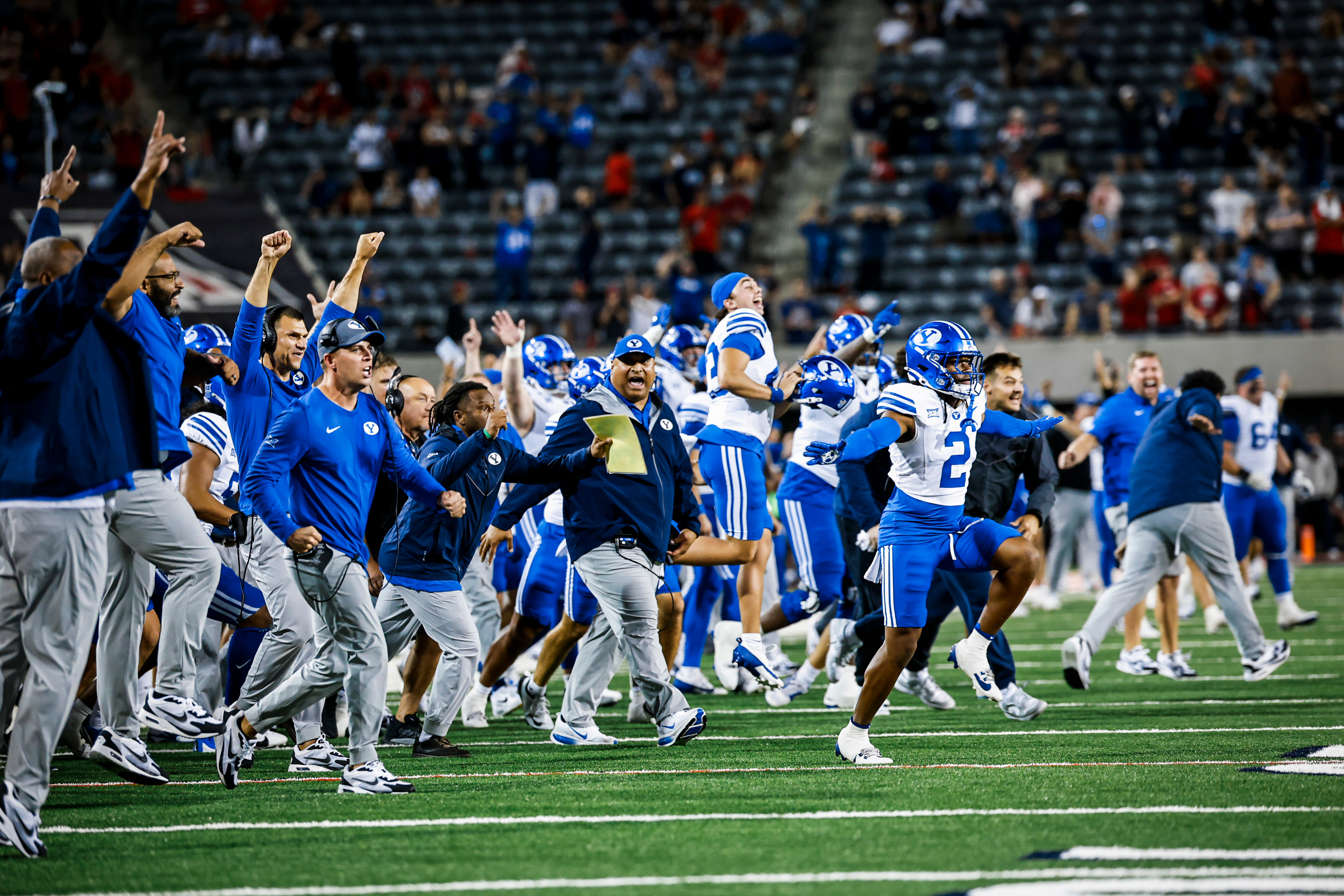 BYU players and coaches celebrate a 33-27 double-overtime win during a Big 12 football game against Arizona, Saturday, Oct. 11, 2025 in Tucson, Arizona.