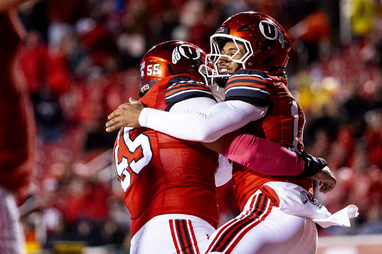 Utah quarterback Byrd Ficklin (15) celebrates his touchdown with offensive lineman Spencer Fano (55) during an NCAA football game against Arizona State held at Rice-Eccles Stadium in Salt Lake City on Saturday, Oct. 11, 2025.
