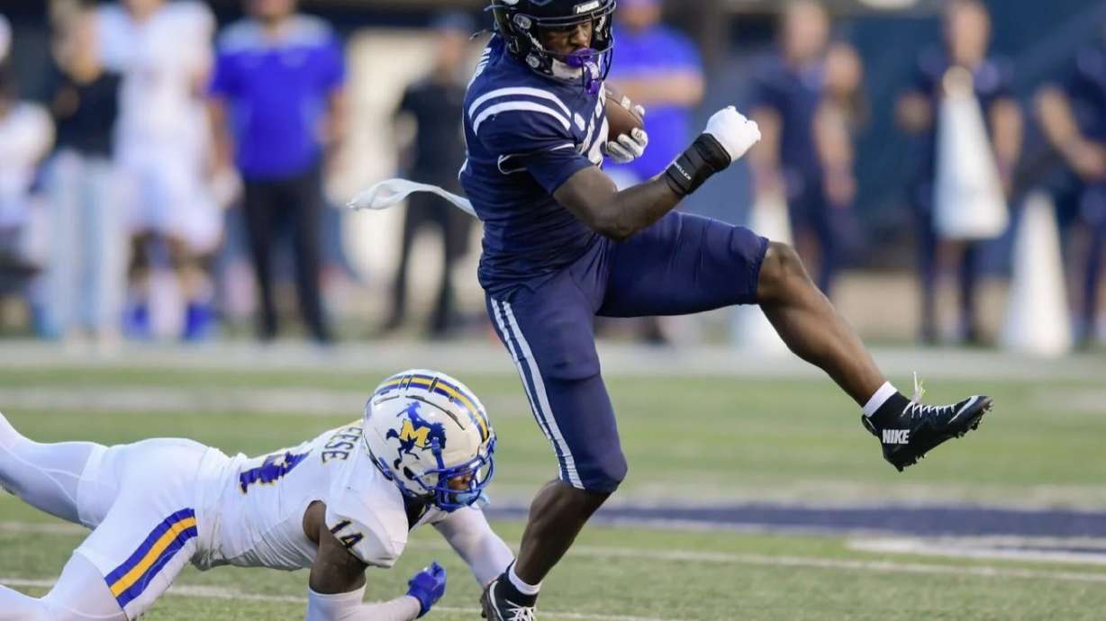 Scre Utah State Aggies running back Miles Davis (2) runs past McNeese State safety Shyaub Brinkley (14) on his way for a 30-yard touchdown in a game last month at Maverik Stadium. Davis rushed for 102 yards in USU's 44-26 road loss to Hawaii in a game that concluded Sunday morning. enshot