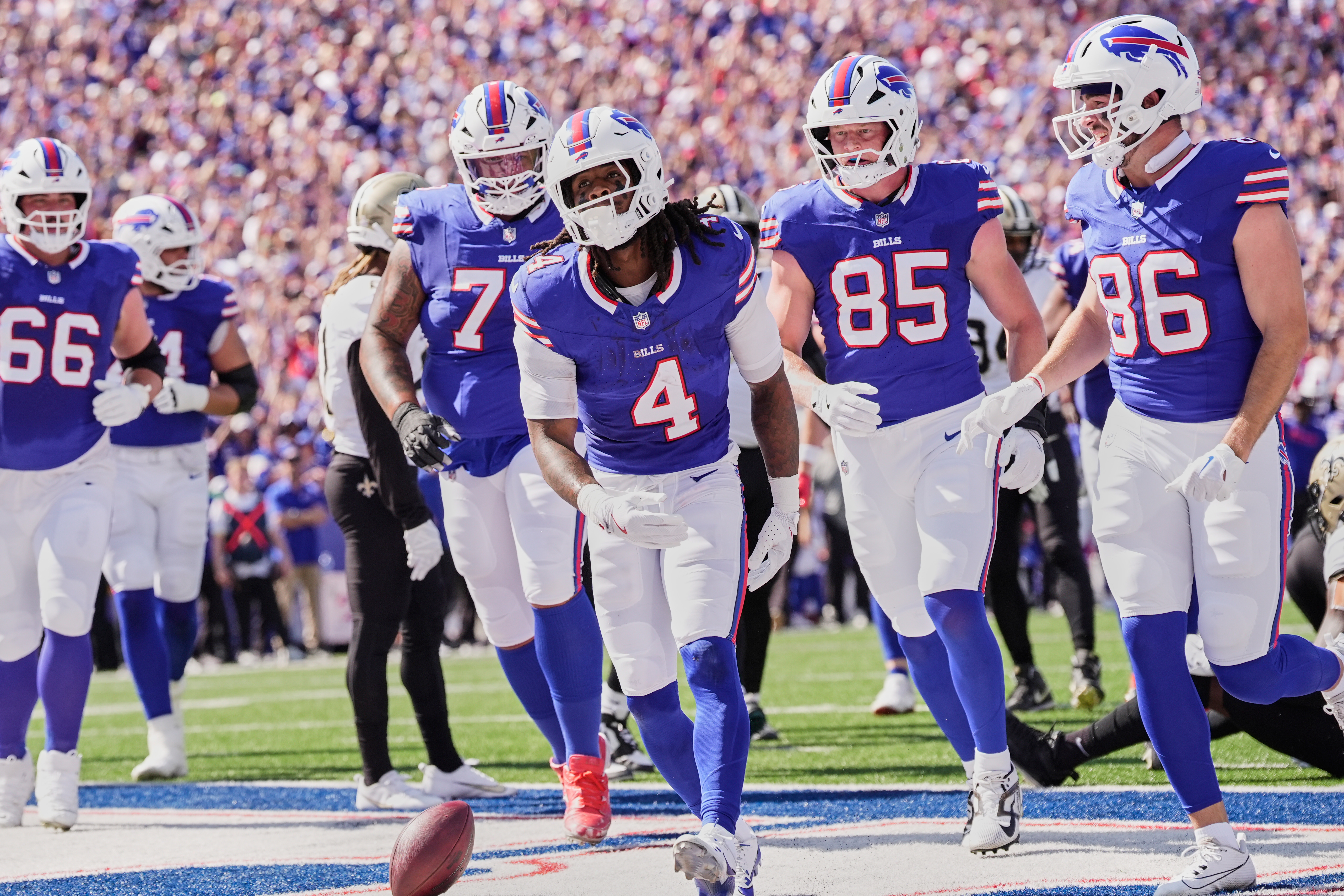 Buffalo Bills running back James Cook (4) celebrates his touchdown against the New Orleans Saints in the first half of an NFL football game, Sunday, Sept. 28, 2025, in Orchard Park, N.Y.