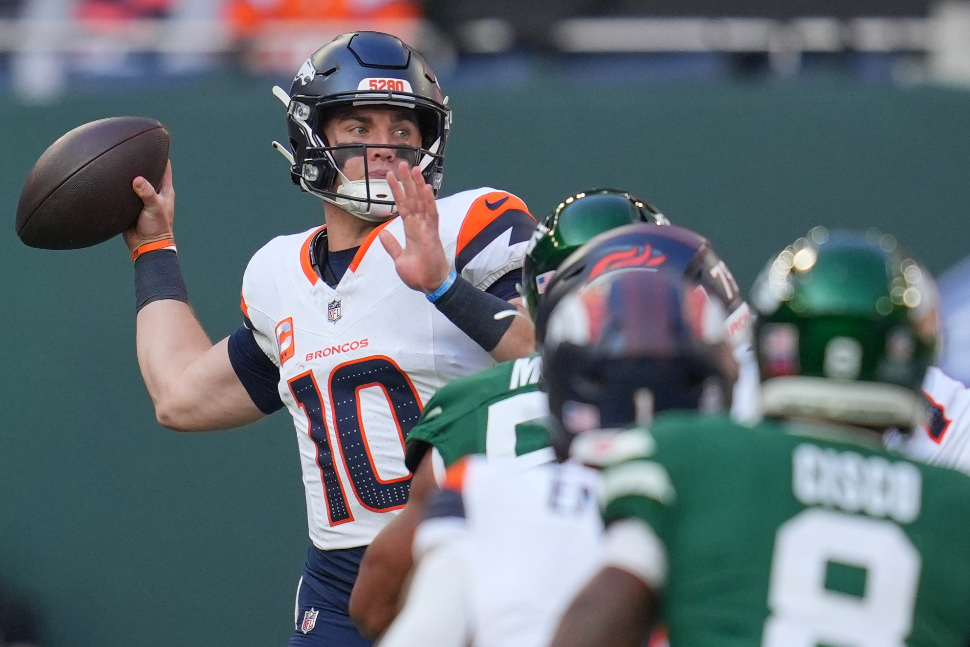 Denver Broncos quarterback Bo Nix passes the ball in the first half of an NFL football game between the Denver Broncos and the New York Jets, Sunday, Oct. 12, 2025, in London.