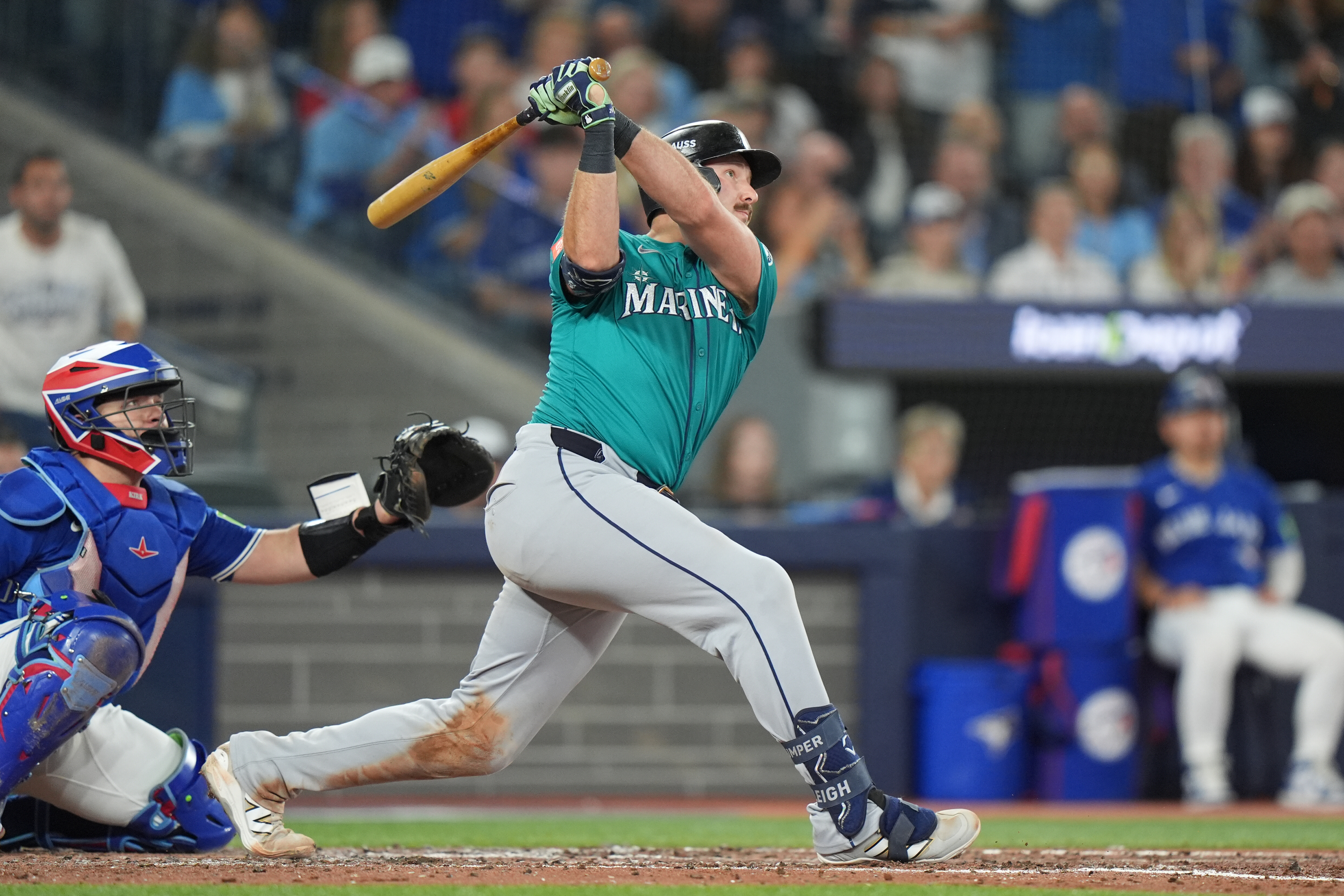 Seattle Mariners' Cal Raleigh (29) hits a home run in front of Toronto Blue Jays catcher Alejandro Kirk (30) sixth inning American League Championship Series baseball action in Toronto on Sunday, Oct. 12, 2025.