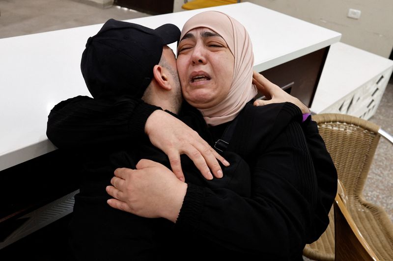 A freed Palestinian is hugged by a relative after he was released from an Israeli jail as part of a hostages-prisoners swap and a ceasefire deal in Gaza between Hamas and Israel, in Ramallah, in the Israeli-occupied West Bank, Monday.