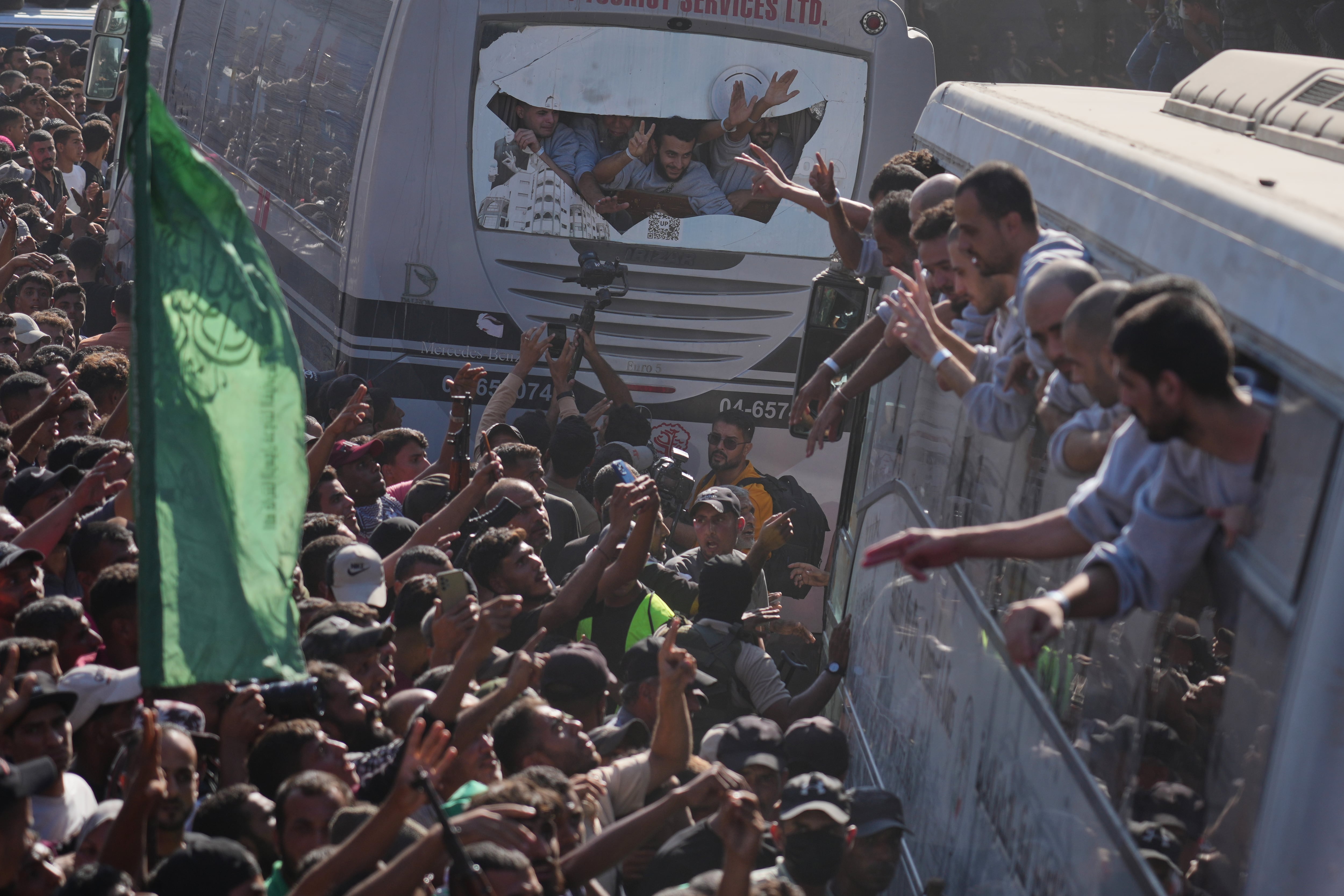 People gather to greet freed Palestinian prisoners arriving on buses in the Gaza Strip after their release from Israeli jails under a ceasefire agreement between Hamas and Israel, outside Nasser Hospital in Khan Younis, southern Gaza Strip, Monday.