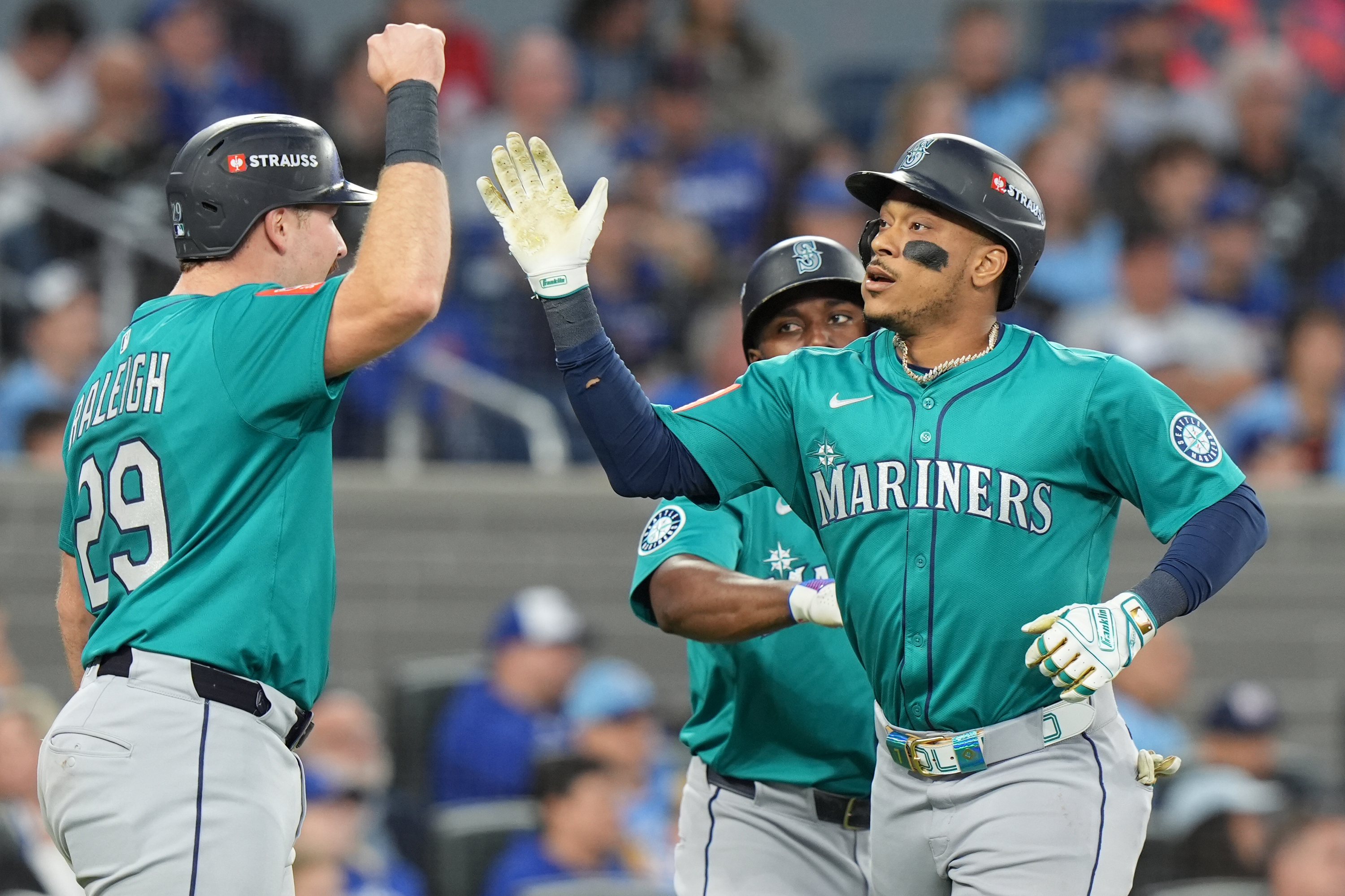 Seattle Mariners' Jorge Polanco, right, celebrates after his a three-run home run with Cal Raleigh (29) during the fifth inning of Game 2 of baseball's American League Division Series against the Toronto Blue Jays in Toronto, Monday, Oct. 13, 2025. 