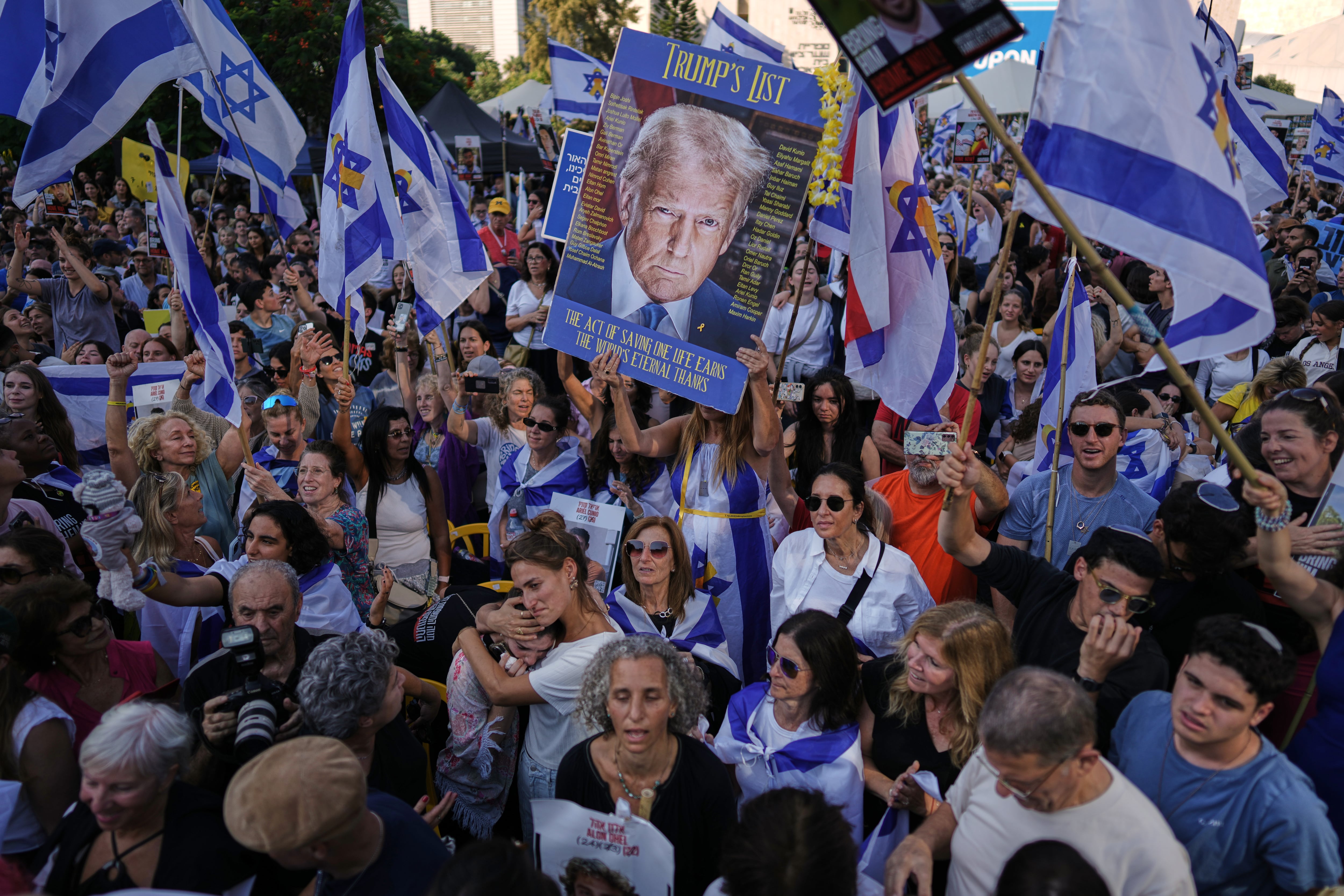 People react as they gather to watch a live broadcast of Israeli hostages released from Gaza at a plaza known as hostages square in Tel Aviv, Israel, Monday. The release took place as part of a cease-fire agreement between Israel and Hamas.