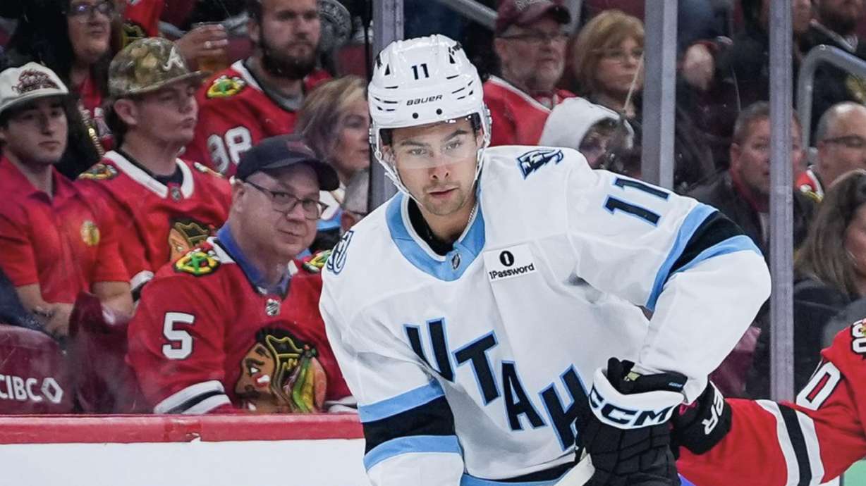 Dylan Guenther looks at the puck against the Chicago Blackhawks.