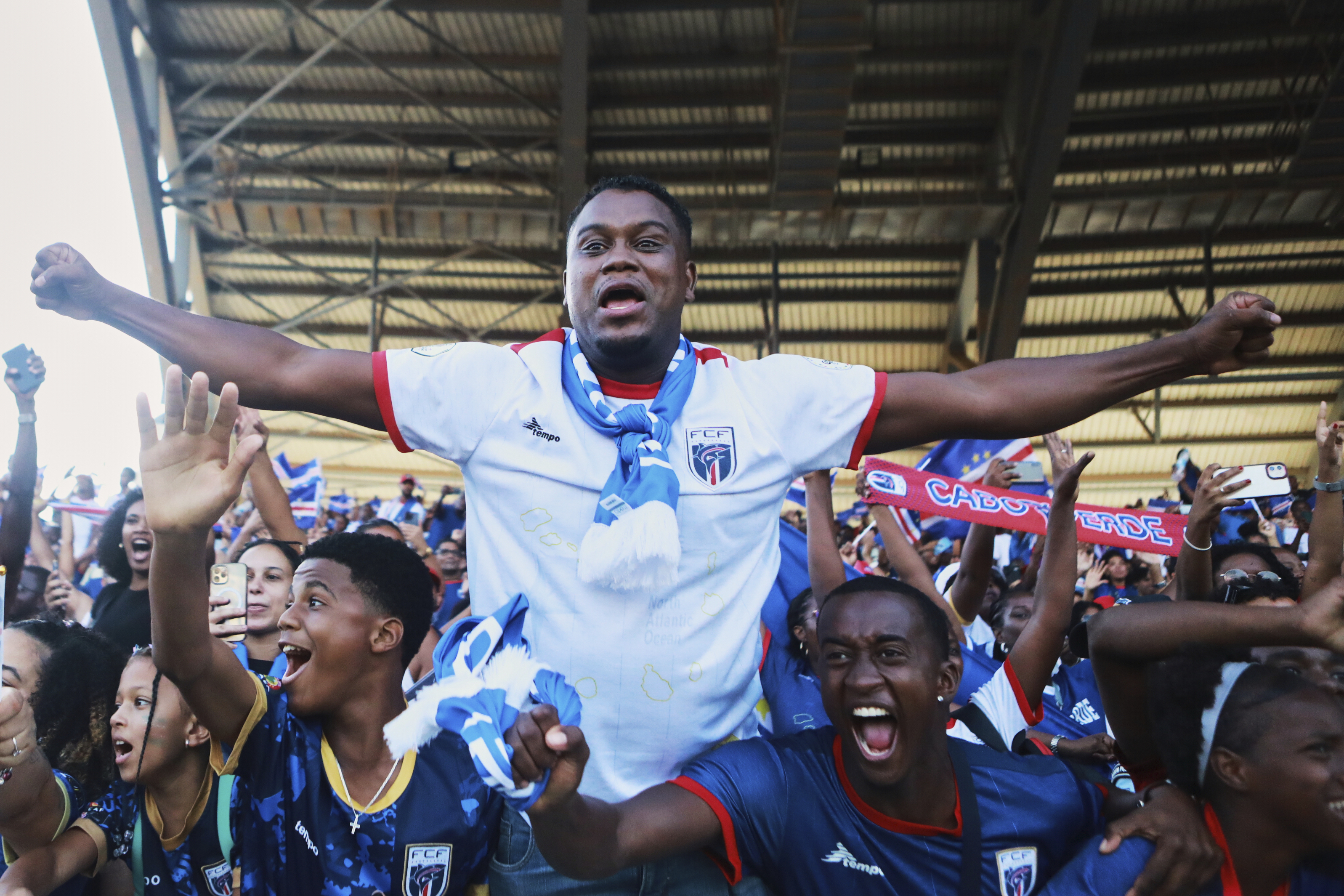 Fans celebrate in the stands after Cape Verde defeated Eswatini in a World Cup qualifying soccer match at Estádio Nacional in Praia, Cape Verde, Monday, Oct. 13, 2025, to clinch their qualification for the 2026 World Cup.