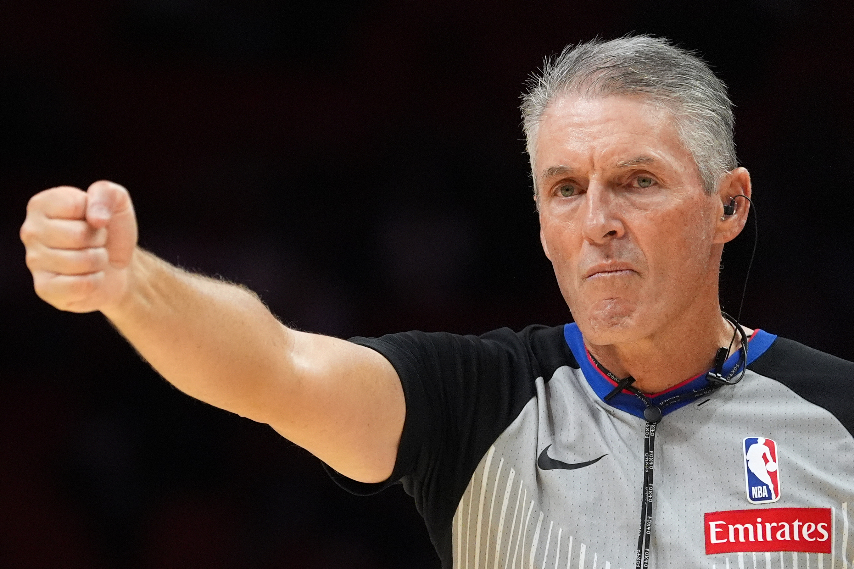 Referee Scott Foster, wearing an earpiece, signals a call during the second half of a preseason NBA basketball game between the Miami Heat and the Milwaukee Bucks, Monday, Oct. 6, 2025, in Miami. 