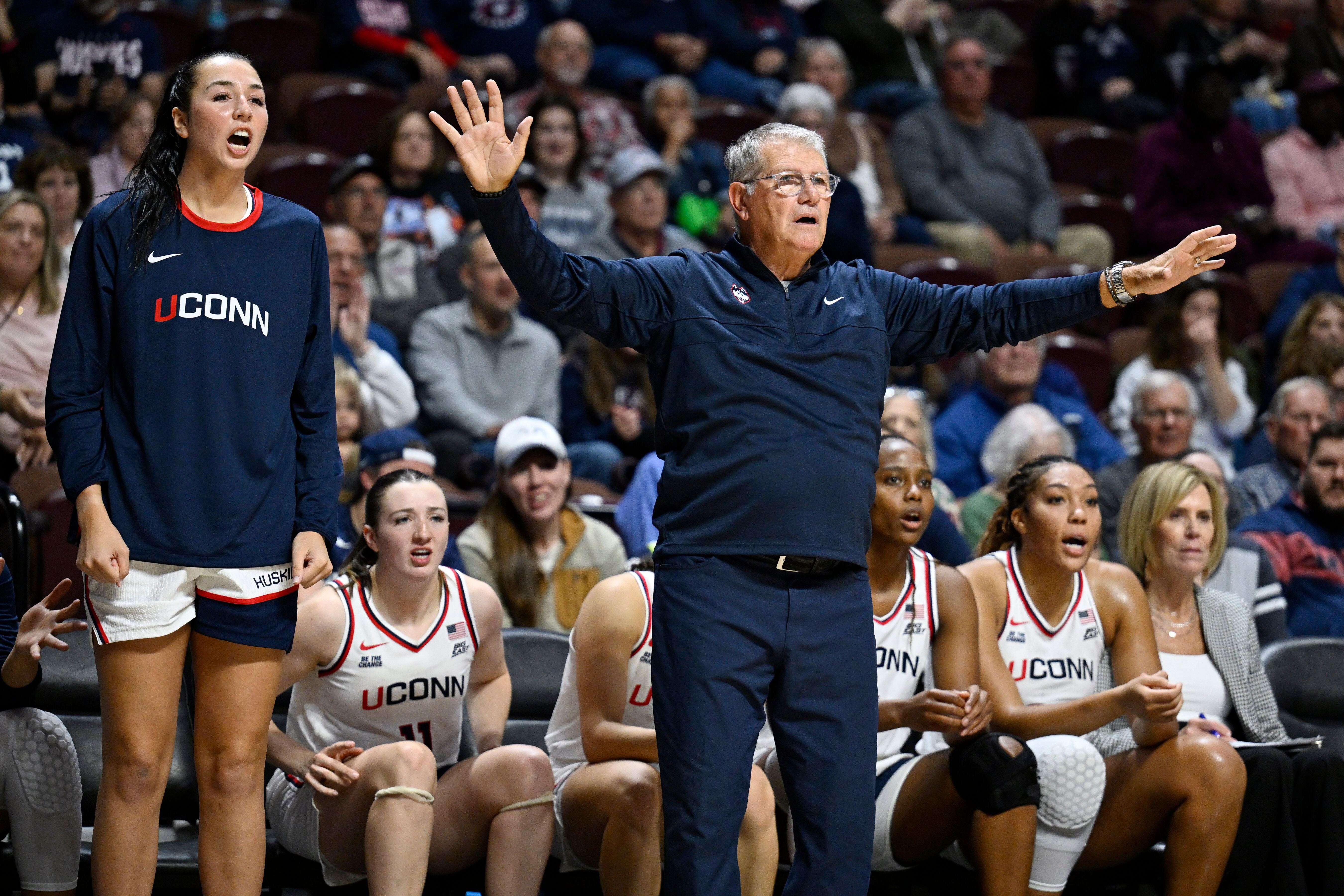 UConn head coach Geno Auriemma gestures as player Caroline Ducharme, left, calls out to their team in the first half of an exhibition NCAA college basketball game against Boston College, Monday, Oct. 13, 2025, in Uncasville, Conn.