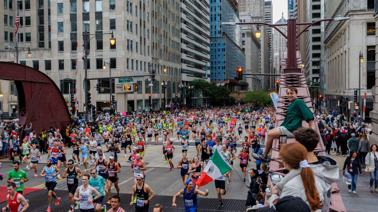 FILE - Runners cross the LaSalle Street bridge during the Chicago Marathon, Sunday, Oct. 13, 2024, in Chicago.