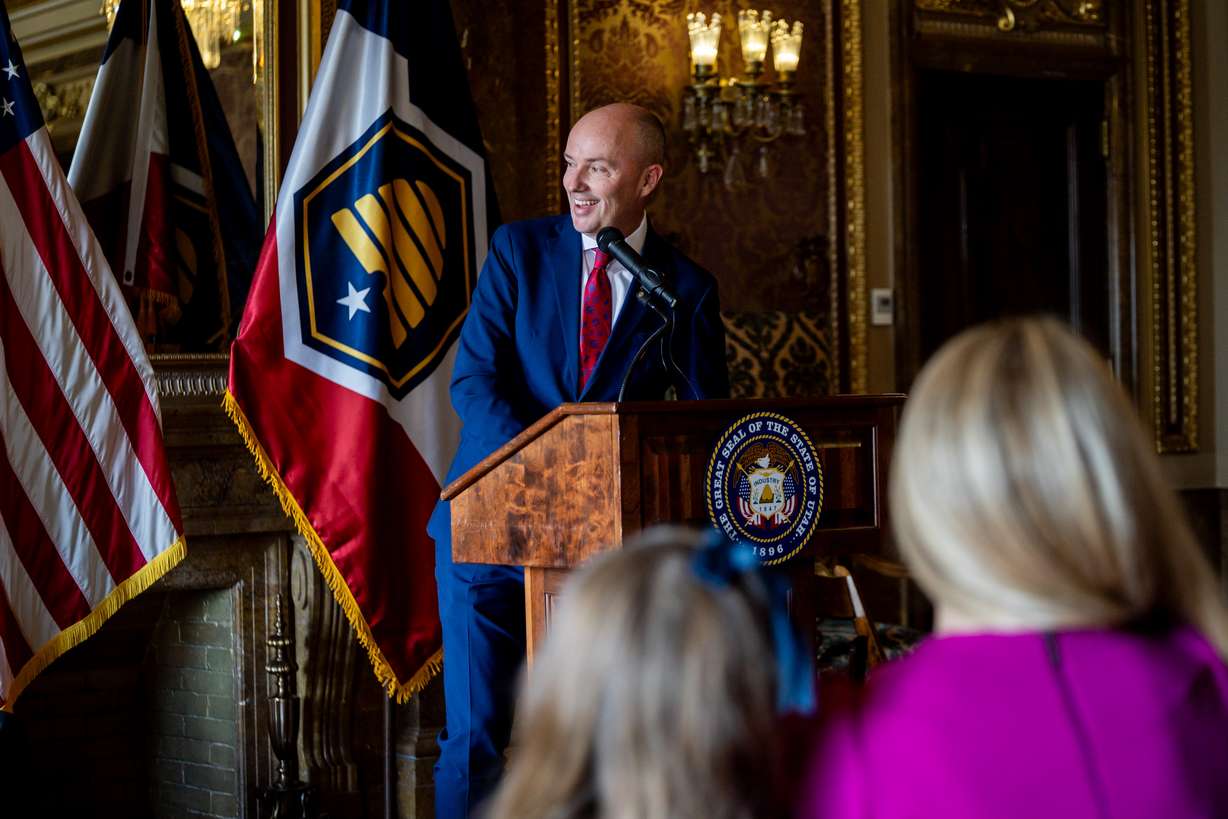 Mandy Nielsen, wife of Judge John Nielsen, right, and Hope Nielsen, 7, daughter of Nielsen, left, listen as Gov. Spencer Cox speaks at a press conference for his nomination of Judge Nielsen for the Utah Supreme Court at the Capitol in Salt Lake City on Tuesday.