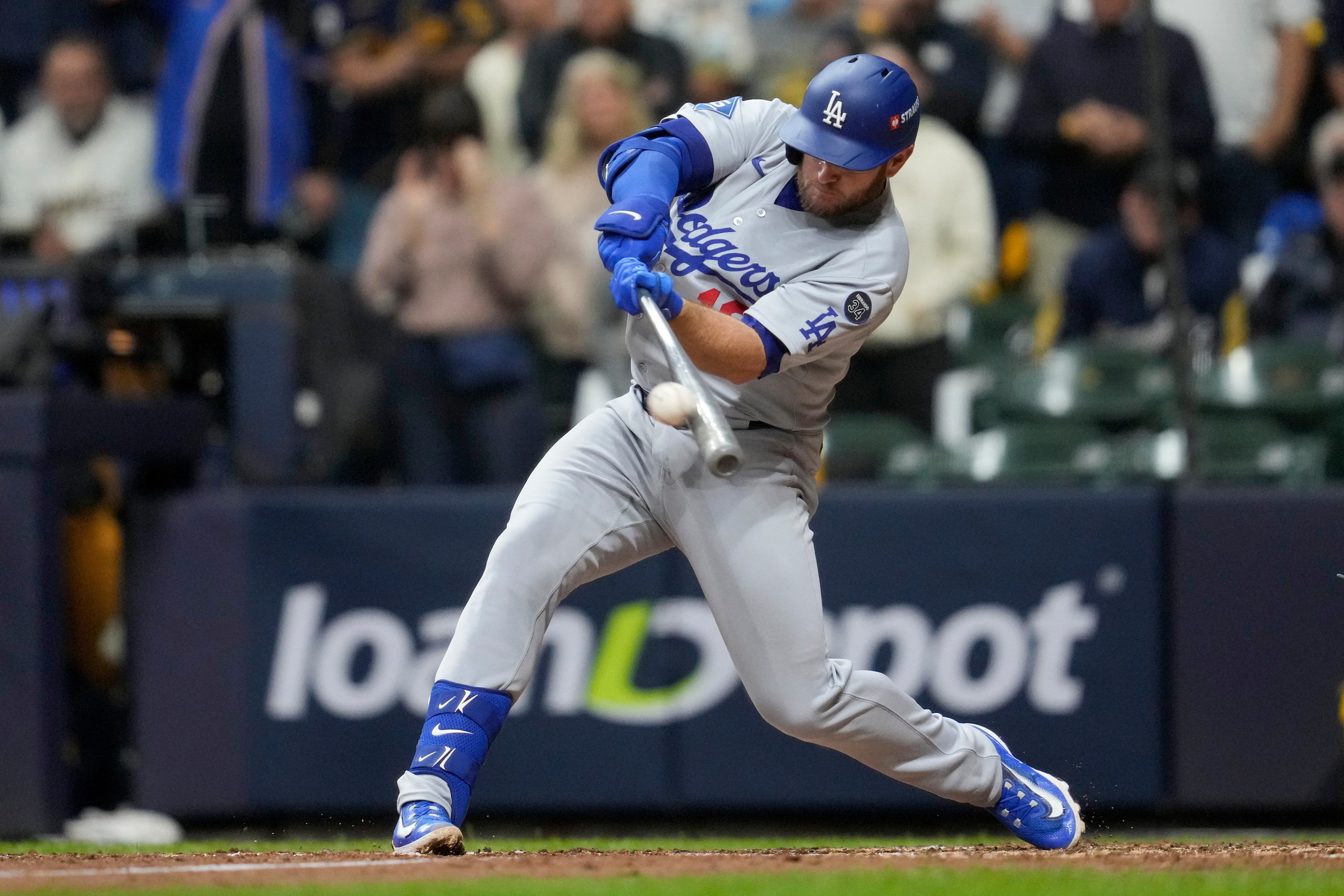 Los Angeles Dodgers' Max Muncy hits a home run against the Milwaukee Brewers during the sixth inning in Game 2 of baseball's National League Championship Series, Tuesday, Oct. 14, 2025, in Milwaukee.