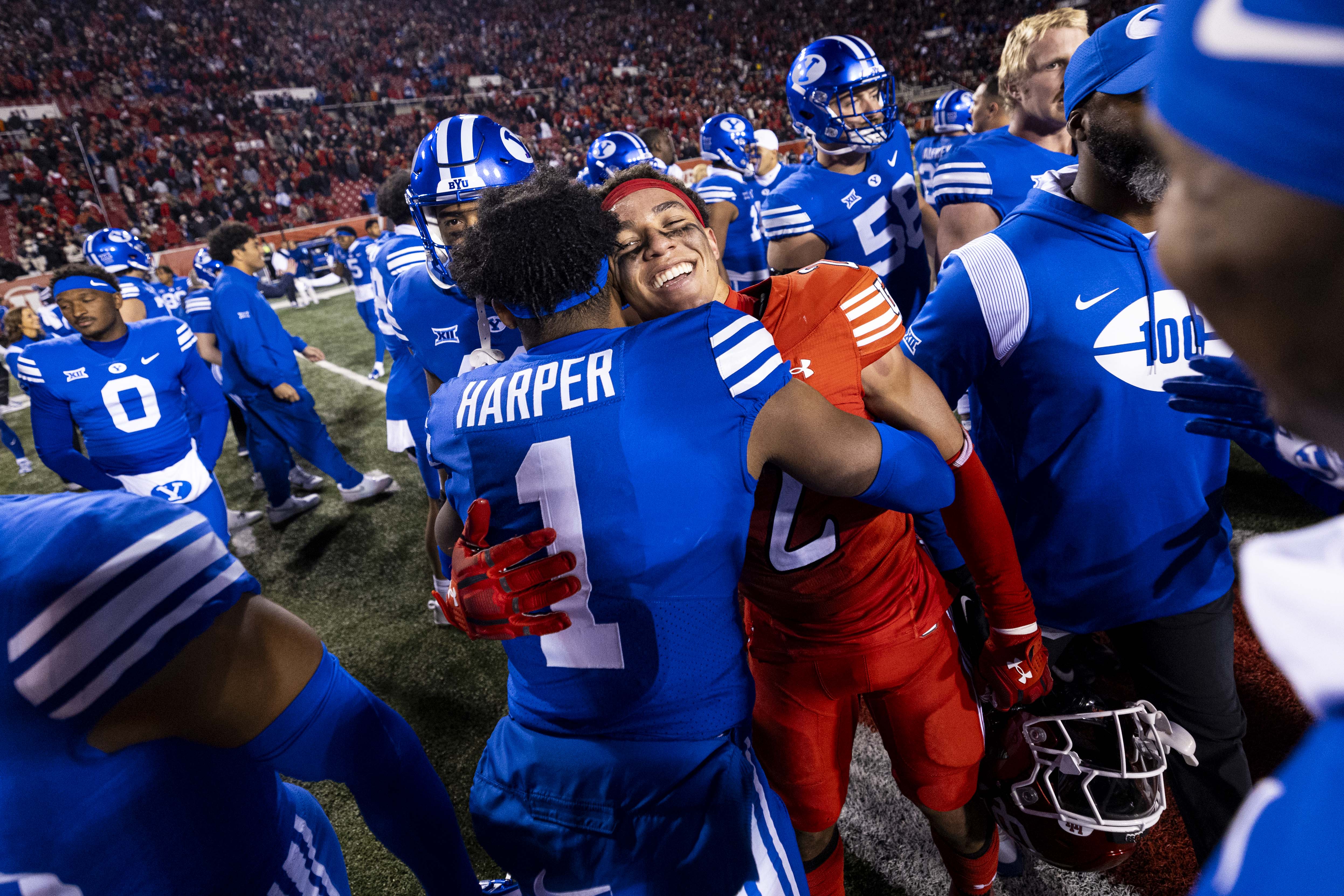 BYU safety Micah Harper (1) hugs Utah Utes cornerback Smith Snowden (2) after the Brigham Young University Cougars defeated the University of Utah Utes 22-21 at Rice-Eccles Stadium in Salt Lake City early on Nov. 10, 2024.