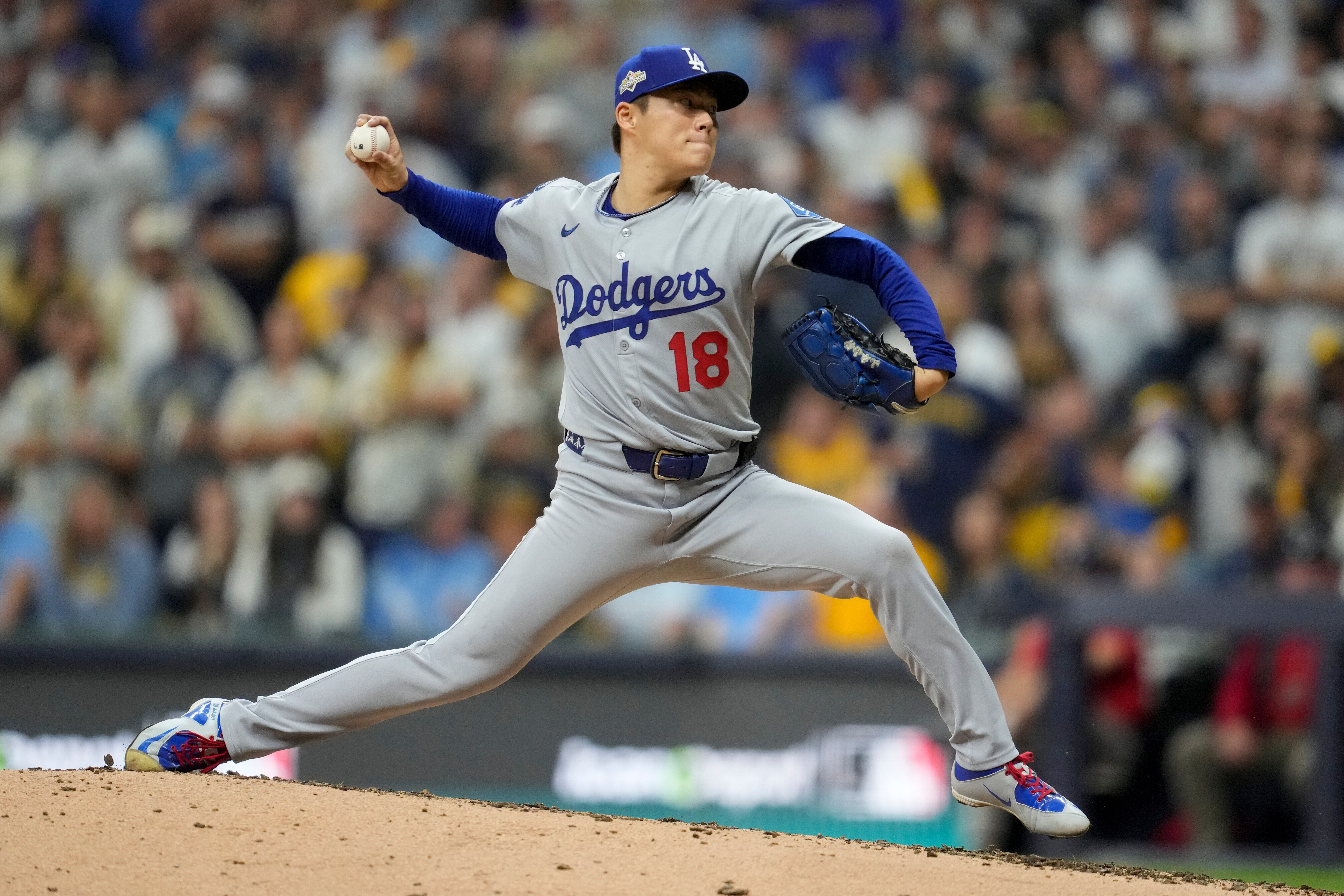 Los Angeles Dodgers pitcher Yoshinobu Yamamoto throws against the Milwaukee Brewers during the fifth inning in Game 2 of baseball's National League Championship Series, Tuesday, Oct. 14, 2025, in Milwaukee.