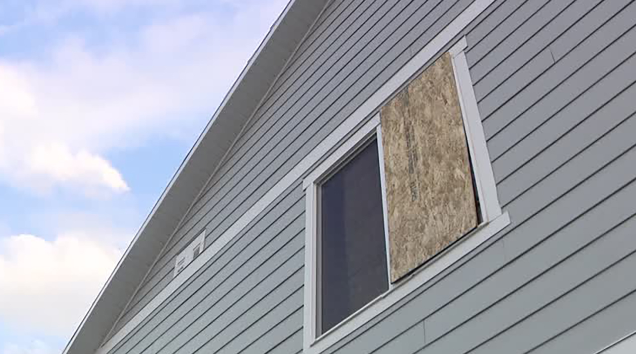 Damage is shown at a Lehi home on Tuesday after a wind storm on Sunday blew a pergola into the side of the house.