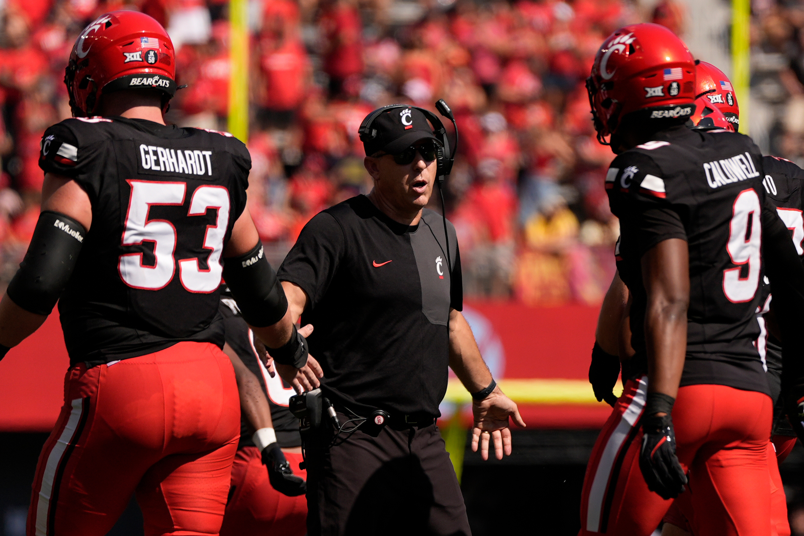 Cincinnati Bearcats head coach Scott Satterfield greets players on the field during the first half of an NCAA college football game against Iowa State , Saturday, Oct. 4, 2025, in Cincinnati.