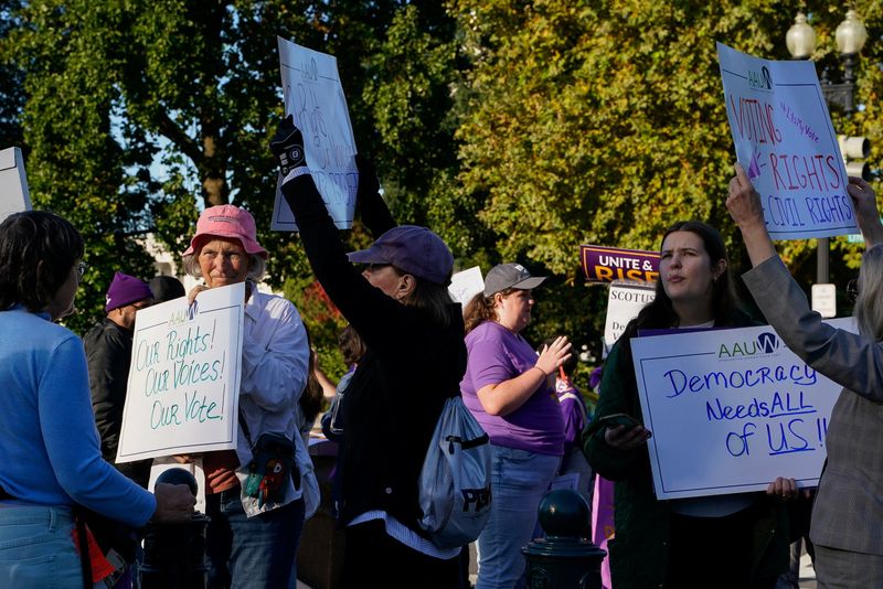 People protest outside the Supreme Court in Washington, Wednesday. The Court is hearing a case that could determine the future of a section of the Voting Rights Act of 1965.