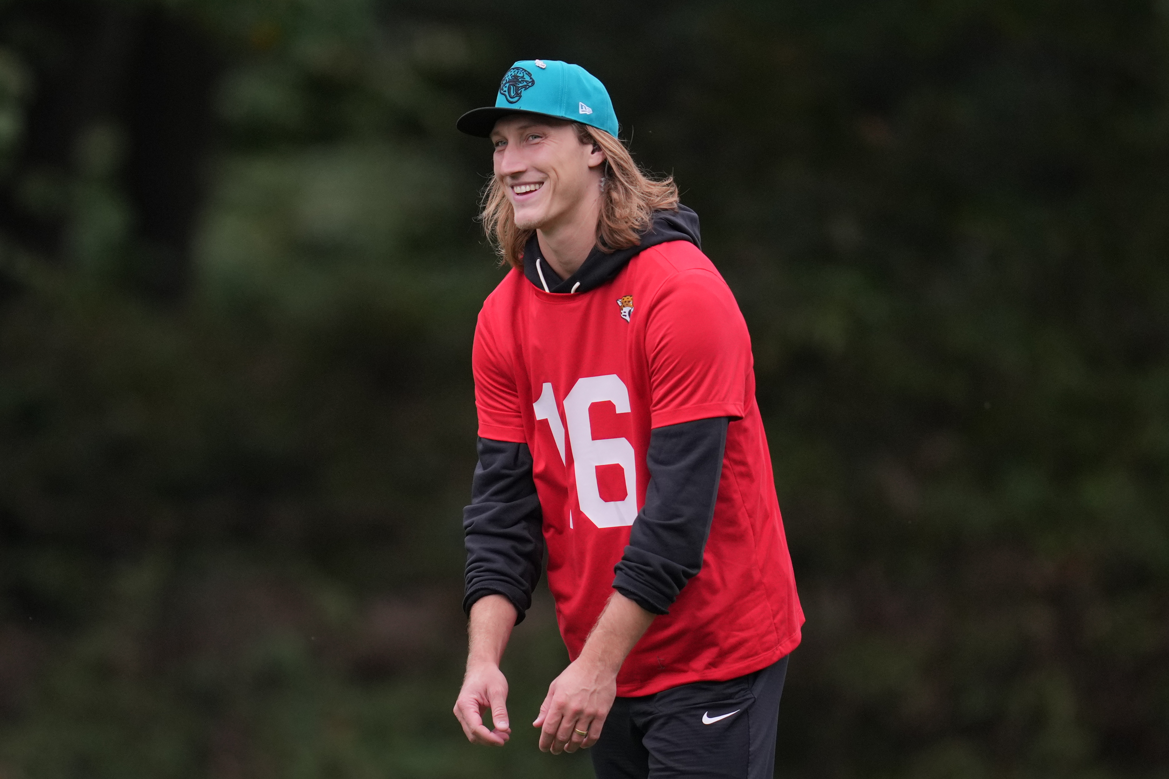 Jacksonville Jaguars quarterback Trevor Lawrence (16) smiles during an NFL football practice at The Grove in Watford, England, Wednesday, Oct. 15, 2025. 