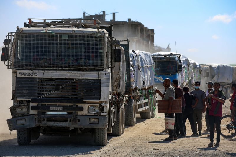 Trucks carry aid for Palestinians, amid a ceasefire between Israel and Hamas in Gaza, in Khan Younis, in the southern Gaza Strip, Tuesday. Longer-term elements of the ceasefire are still being hashed out.
