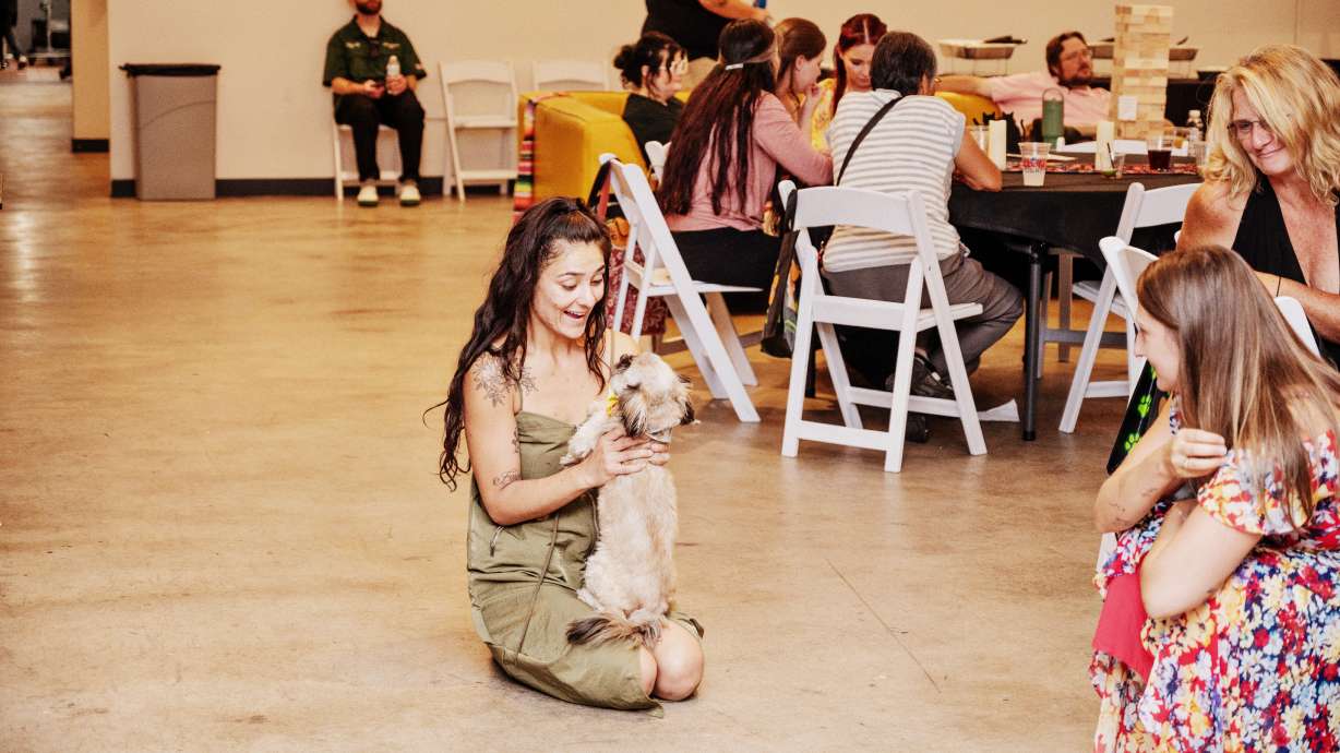 Foster Melia Amos holds Gizmo, a hospice dog currently in her care.