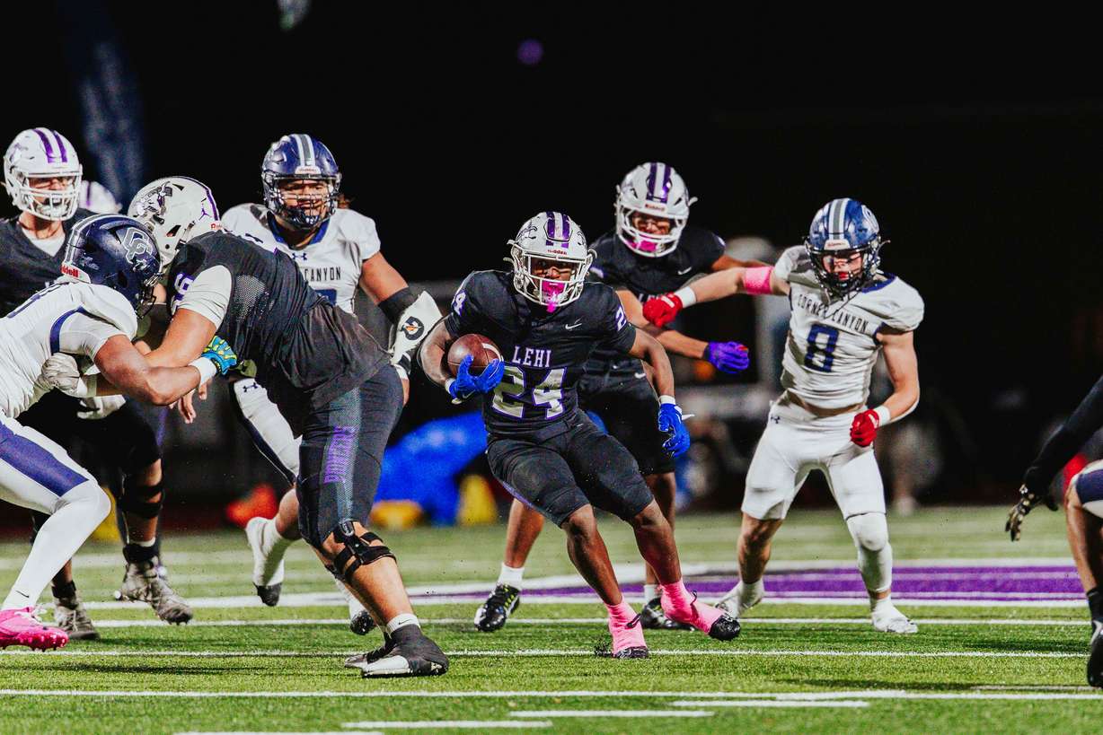 Lehi's Devaughn Eka runs for yardage during a Utah high school football game against Corner Canyon, Wednesday, Oct. 15, 2025.
