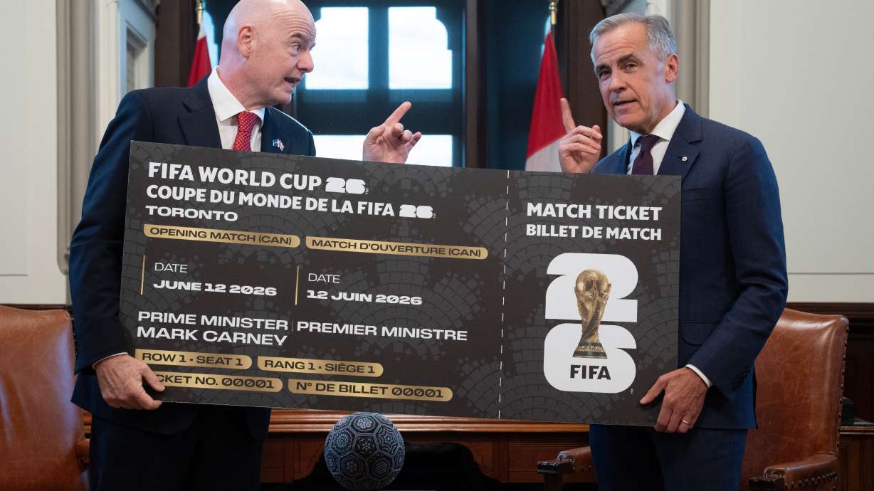 Canada Prime Minister Mark Carney, right, is presented with a novelty World Cup ticket by FIFA President Gianni Infantino on Parliament Hill in Ottawa, Ontario, Friday, Oct. 10, 2025.