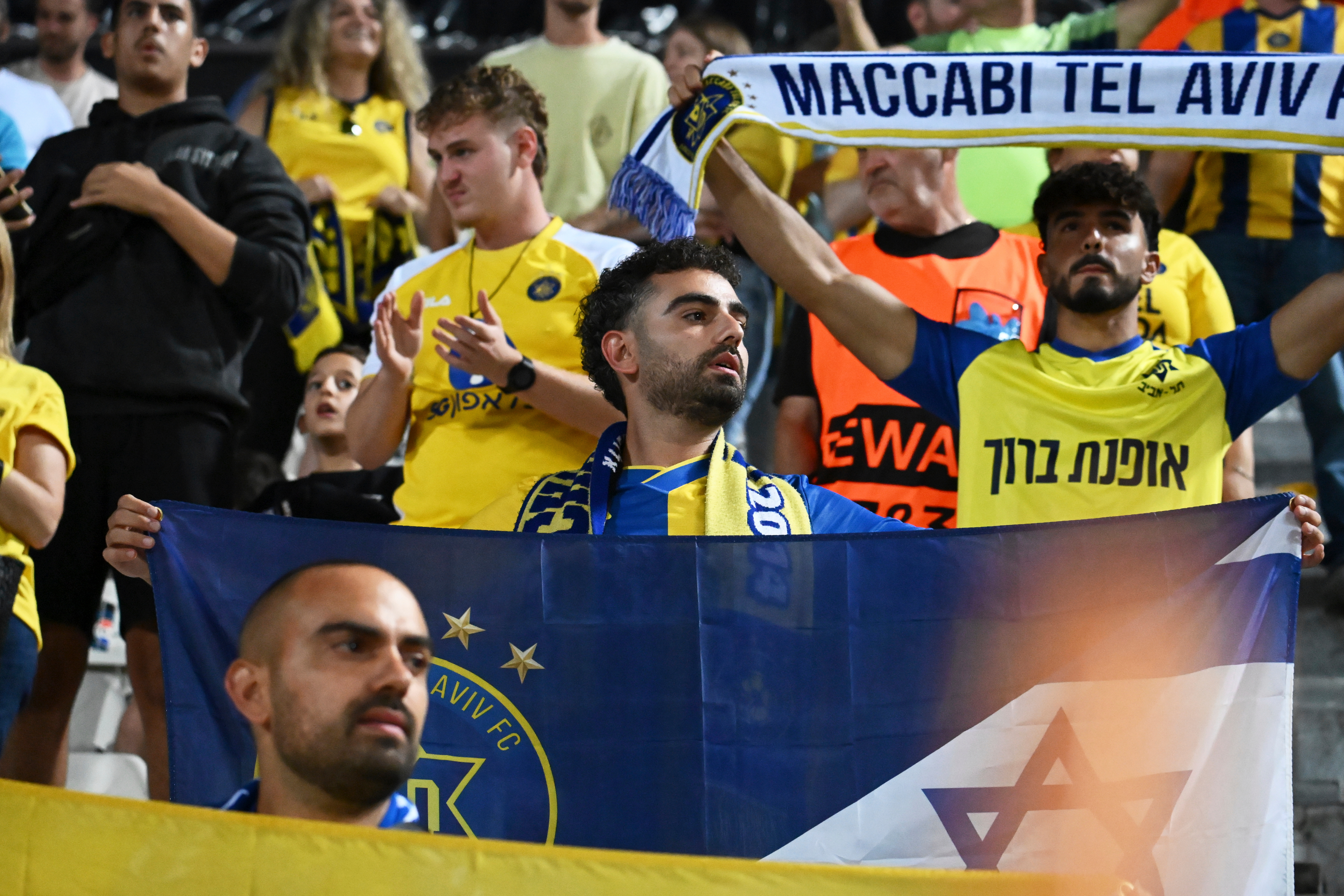 Maccabi Tel Aviv's fans clap hands after the end of the Europa League soccer match between PAOK and Maccabi Tel Aviv at Toumpa stadium, in Thessaloniki, Greece, Wednesday, Sept. 24, 2025. 