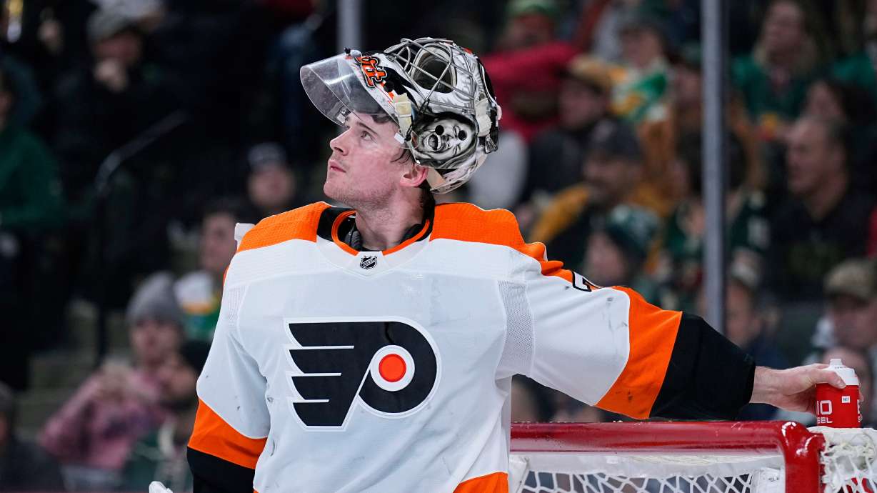 FILE - Philadelphia Flyers goaltender Carter Hart waits for play to resume during the third period of an NHL hockey game against the Minnesota Wild, Thursday, Jan. 26, 2023, in St. Paul, Minn.