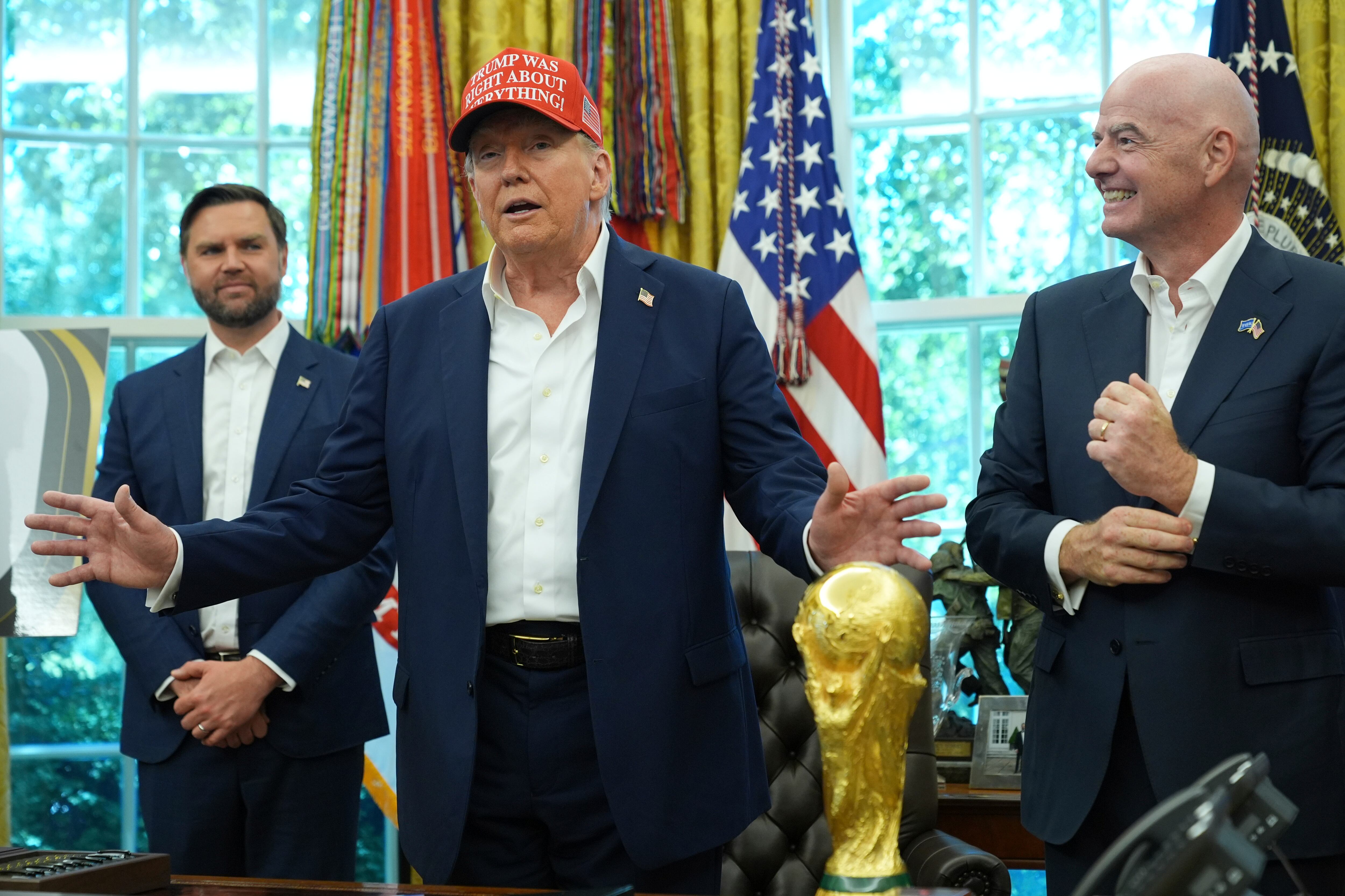 President Donald Trump speaks as FIFA President Gianni Infantino, right, and Vice President JD Vance look on at the conclusion of an announcement in the Oval Office of the White House, Aug. 22, in Washington.