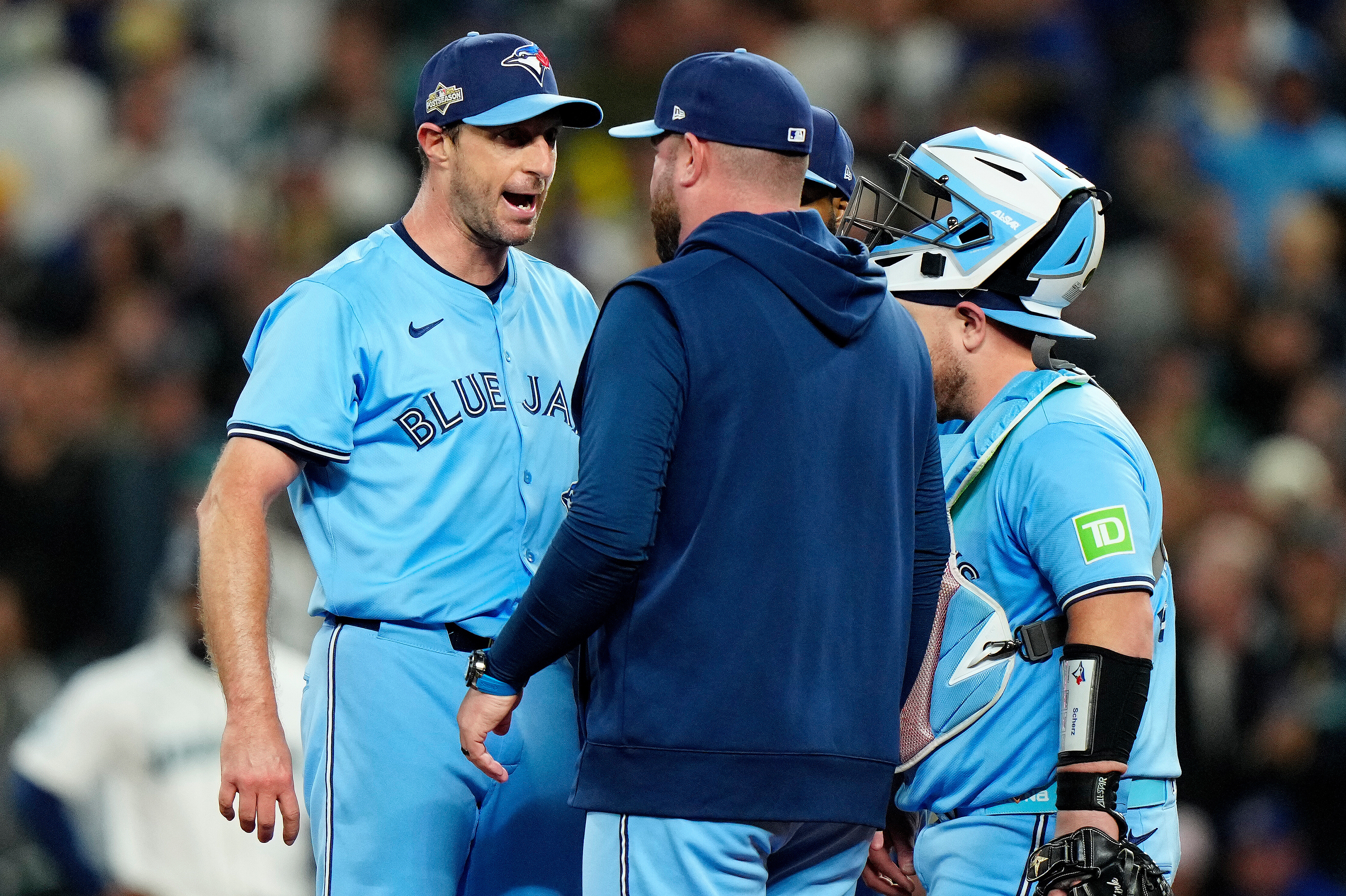Toronto Blue Jays pitcher Max Scherzer (31) shares some words with Toronto Blue Jays manager John Schneider during a visit to the mound in fifth inning MLB American League Championship Series game 4 baseball action against the Seattle Mariners, in Seattle, Thursday, Oct. 16, 2025. 