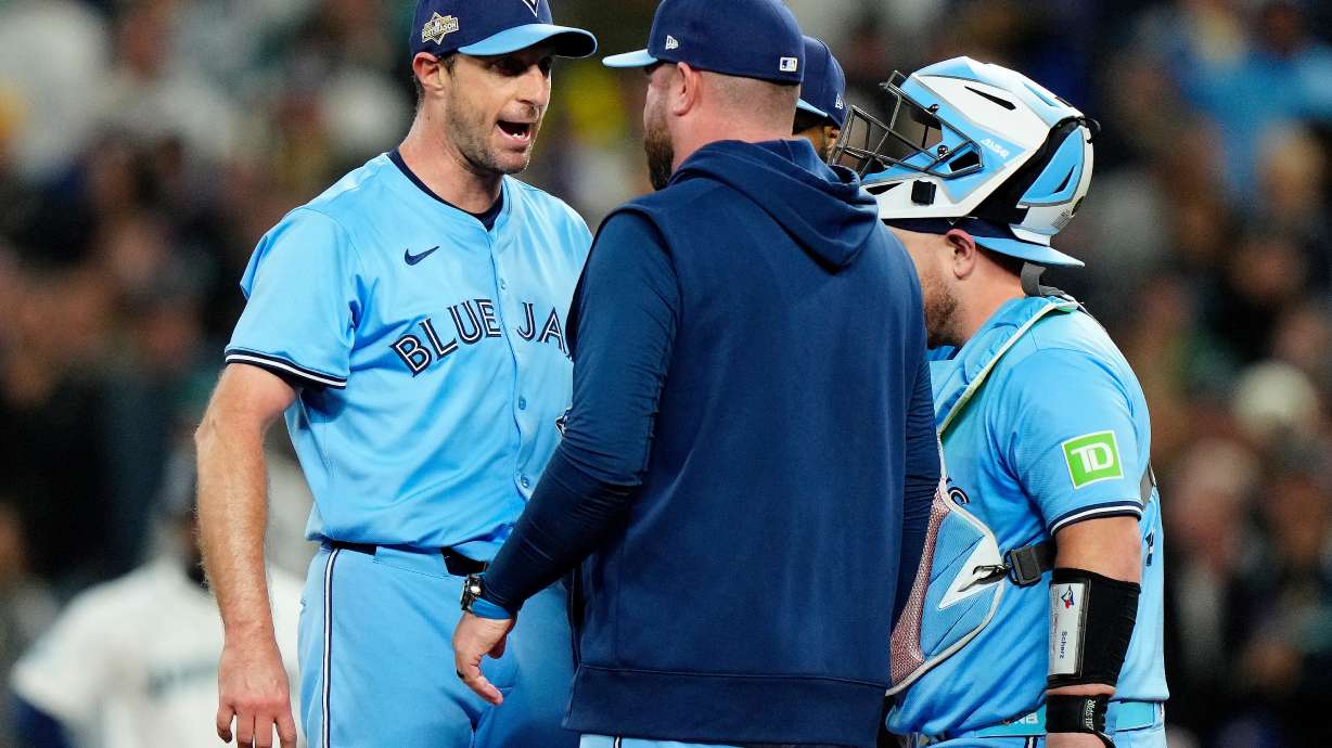 Toronto Blue Jays pitcher Max Scherzer (31) shares some words with Toronto Blue Jays manager John Schneider during a visit to the mound in fifth inning MLB American League Championship Series game 4 baseball action against the Seattle Mariners, in Seattle, Thursday, Oct. 16, 2025.
