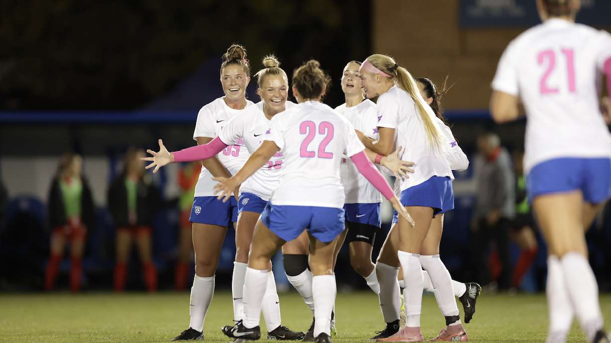 BYU women's soccer players celebrate one of Ellie Walbruch's three goals during a 3-2 win over Arizona, Thursday, Oct. 16, 2025 at South Field in Provo, Utah.