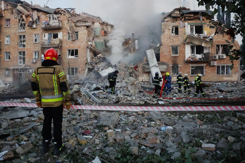Rescuers work at the site of an apartment building which was hit by Russian missile and drone strikes in Kyiv, Ukraine, Aug. 28. The war has intensified with both sides trading strikes on critical infrastructure.