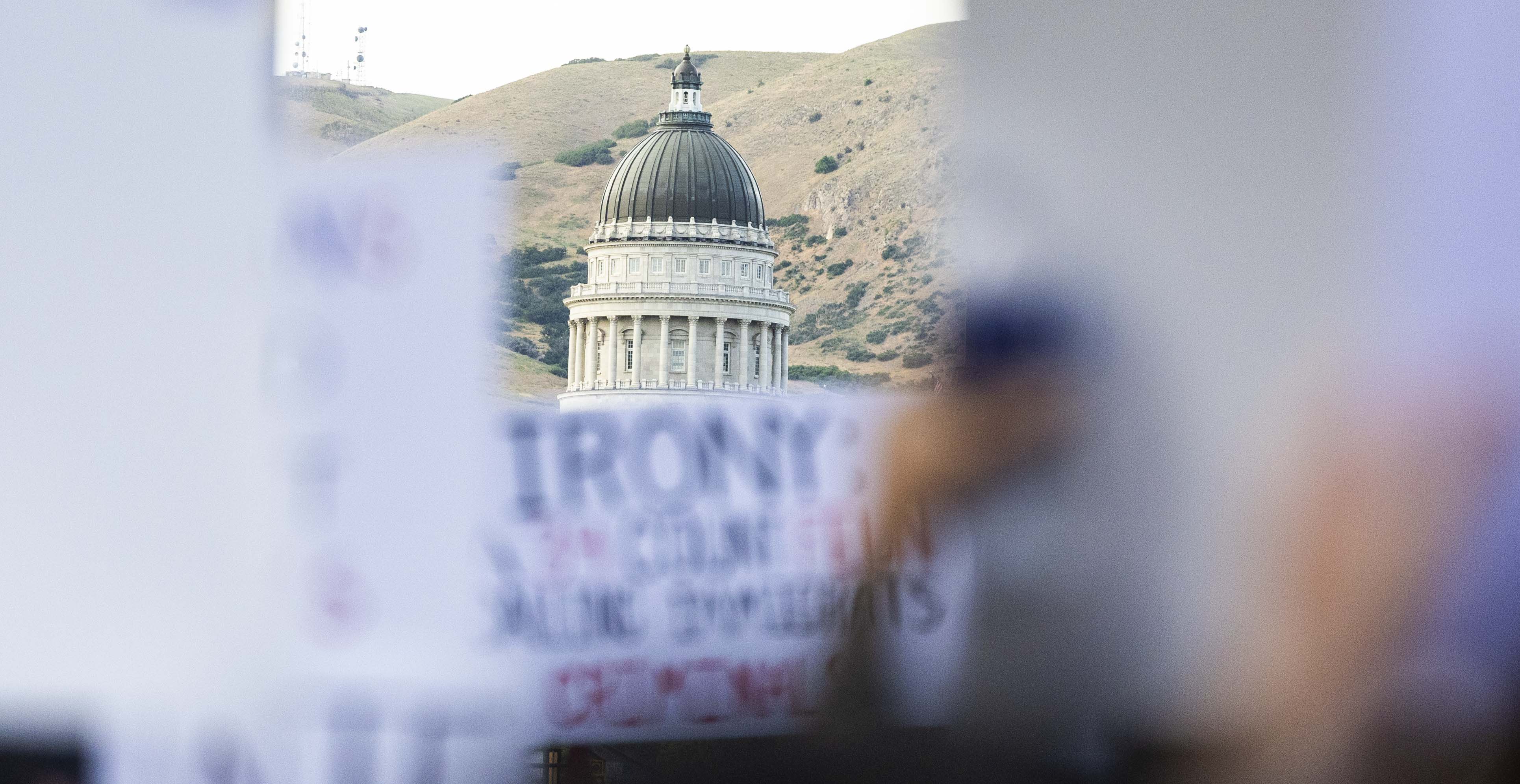 Protester signs obscure the view of the Capitol building from State Street during a “No Kings” protest and march in Salt Lake City on June 14. Thousands of people will participate in a "No Kings" protest Saturday, Oct. 18.