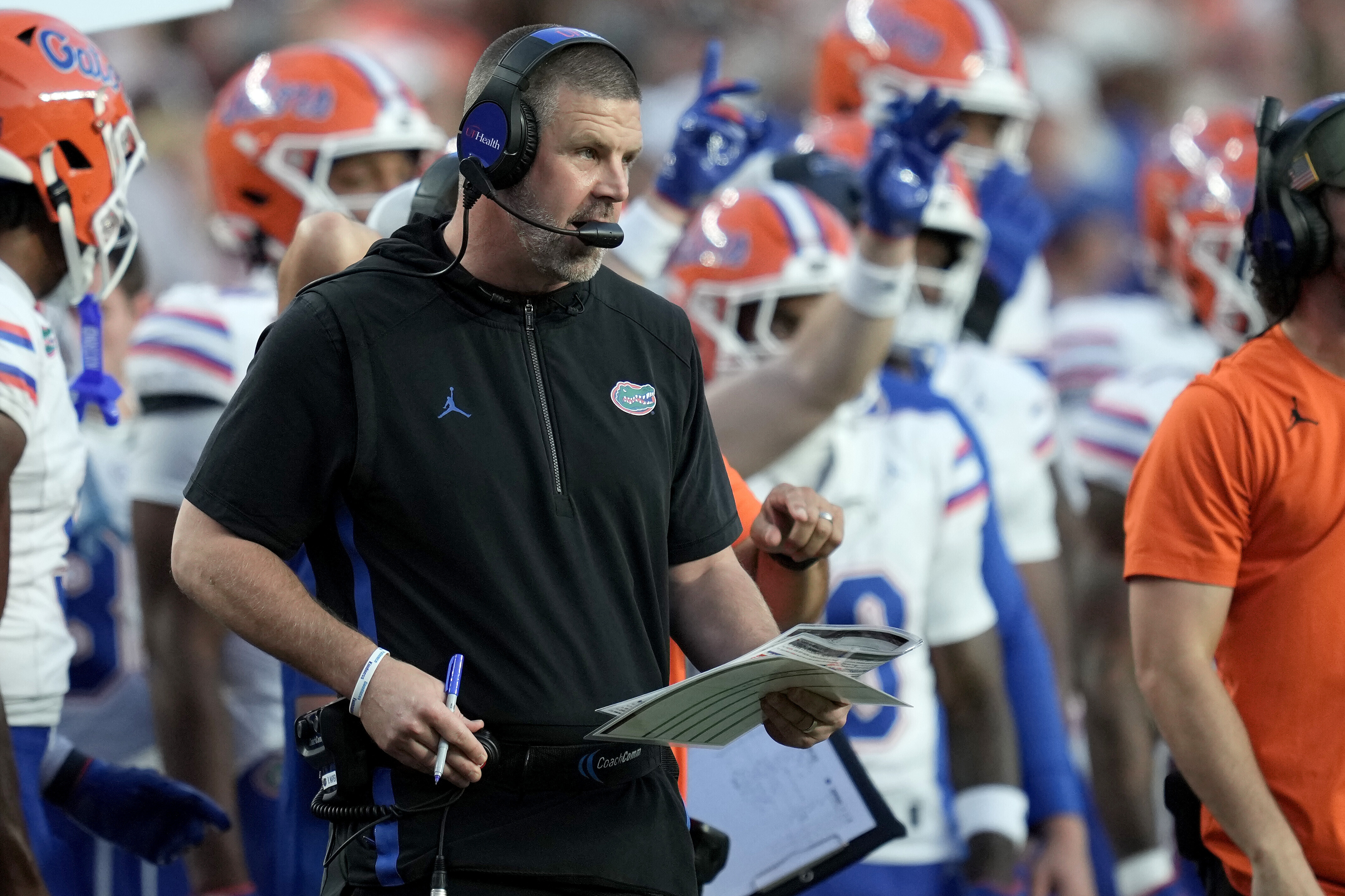 Florida head coach Billy Napier calls in plays to his offense during the first quarter of an NCAA college football game against Texas A&M on Saturday, Oct. 11, 2025, in College Station, Texas.