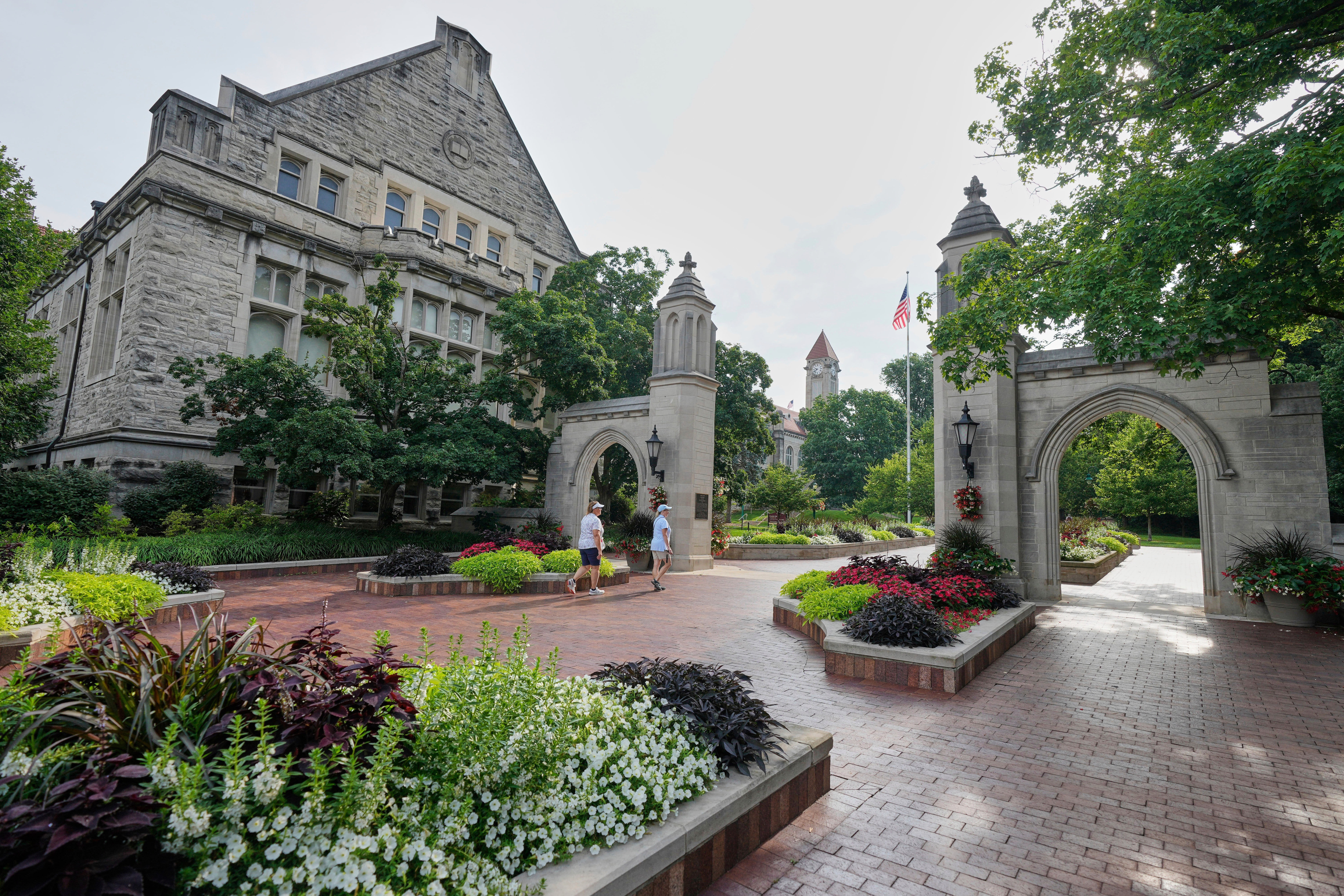 FILE - Guests walk on the campus of Indiana University, Thursday, July 17, 2025, in Bloomington, Ind.