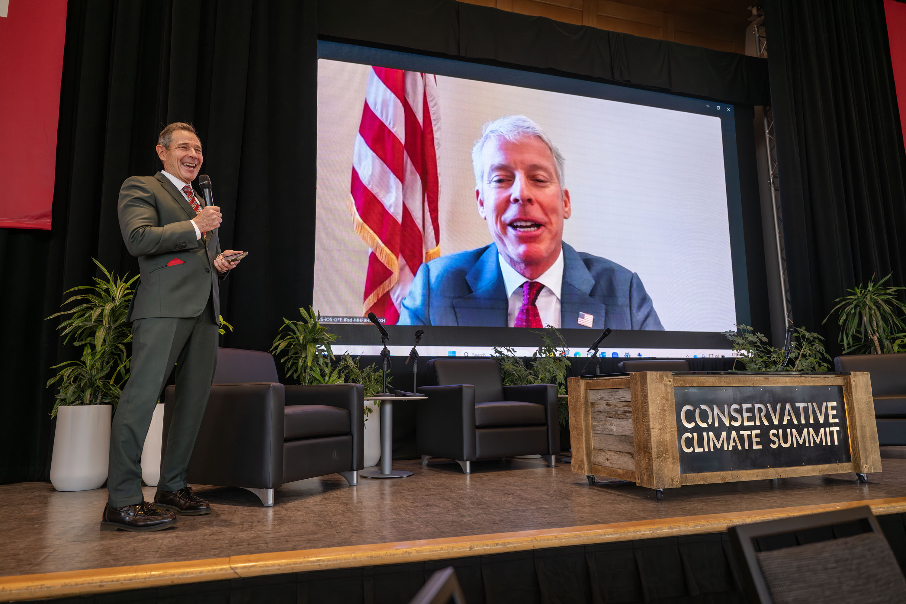 Sen. John Curtis, R-Utah, talks with Energy Secretary Chris Wright on a video call at the 4th Annual Conservative Climate Summit at the University of Utah in Salt Lake City on Friday.