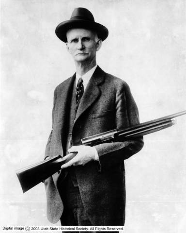 John M Browning with a shotgun he designed.
