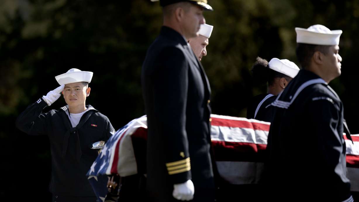 Sailors with the Navy Reserve Center in Salt Lake City carry the casket of Utah native Ensign Howard Holding in the Salt Lake City Cemetery on Friday. Holding was declared missing in action but his remains were finally recovered and he was laid to rest.