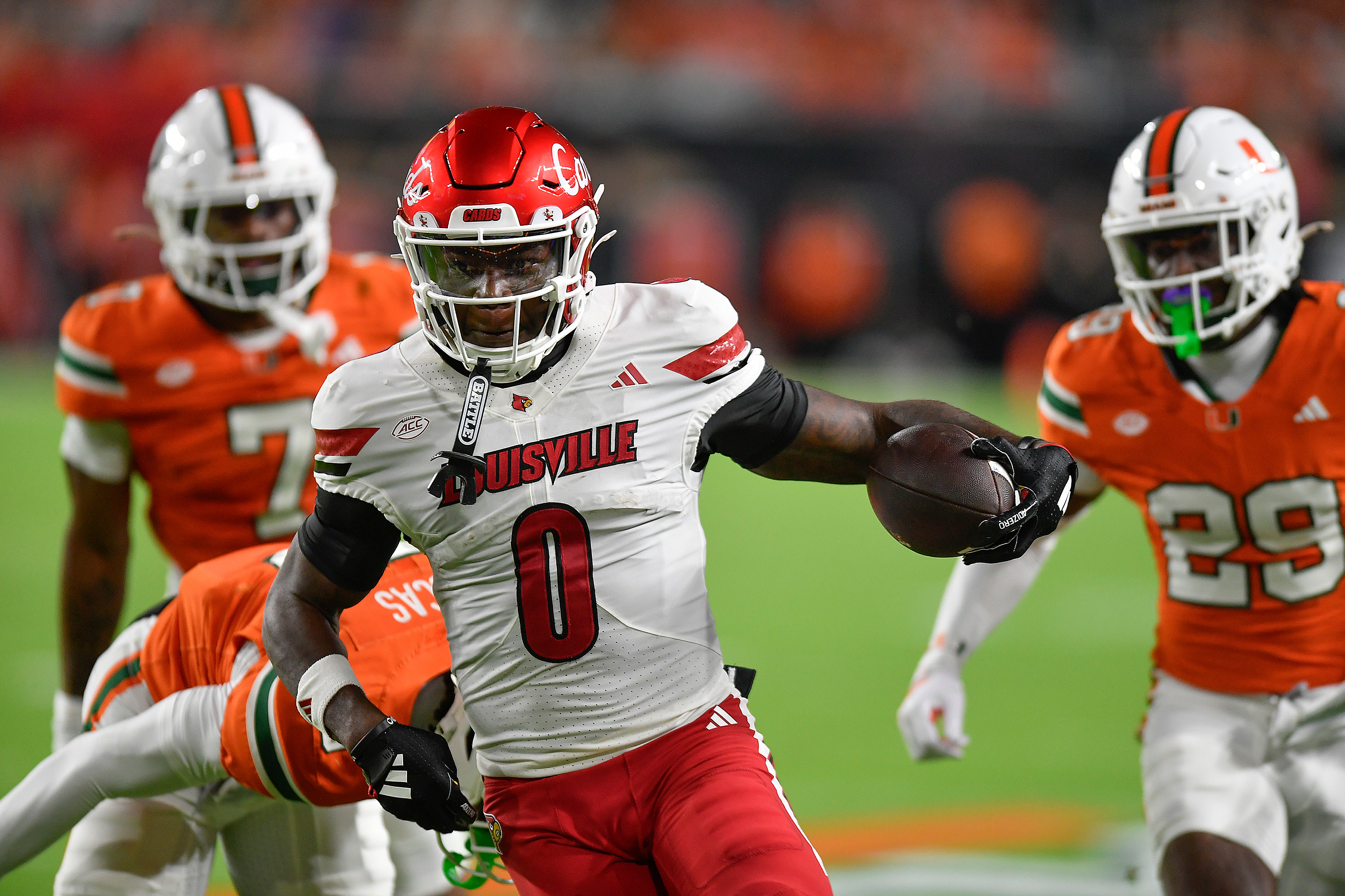 Louisville wide receiver Chris Bell (0) runs for a touchdown during the first half of an NCAA college football game against Miami, Friday, Oct. 17, 2025, in Miami Gardens, Fla.