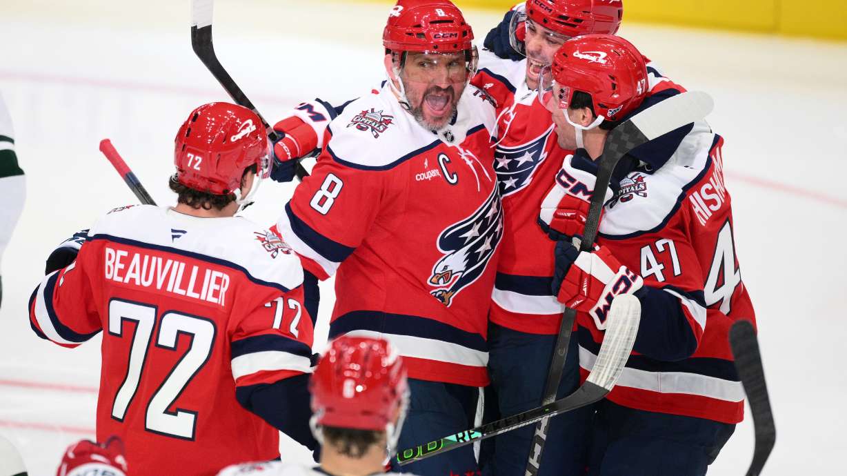 Washington Capitals left wing Alex Ovechkin (8) celebrates his goal with teammates during the third period of an NHL hockey game against the Minnesota Wild, Friday, Oct. 17, 2025, in Washington.