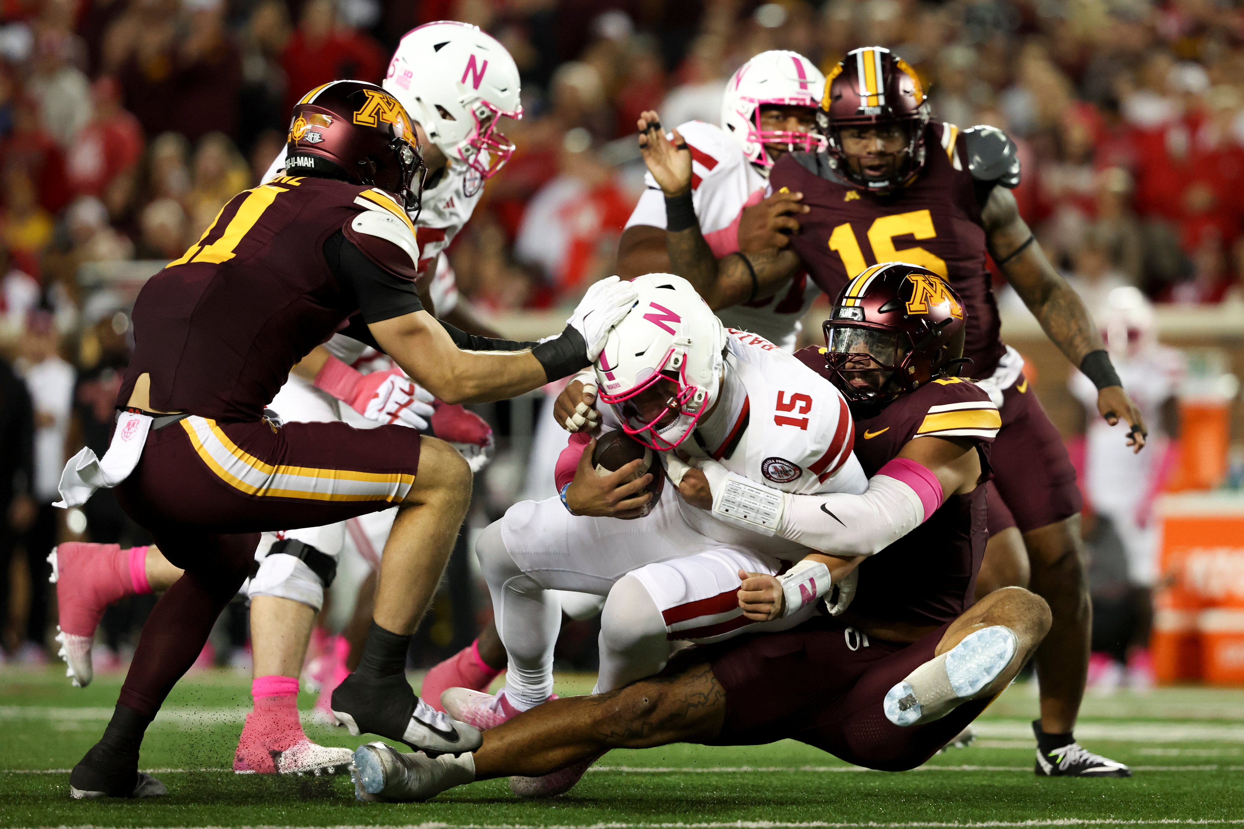 Minnesota defensive lineman Anthony Smith, right, sacks Nebraska quarterback Dylan Raiola (15) during the first half of an NCAA college football game, Friday, Oct. 17, 2025, in Minneapolis. 