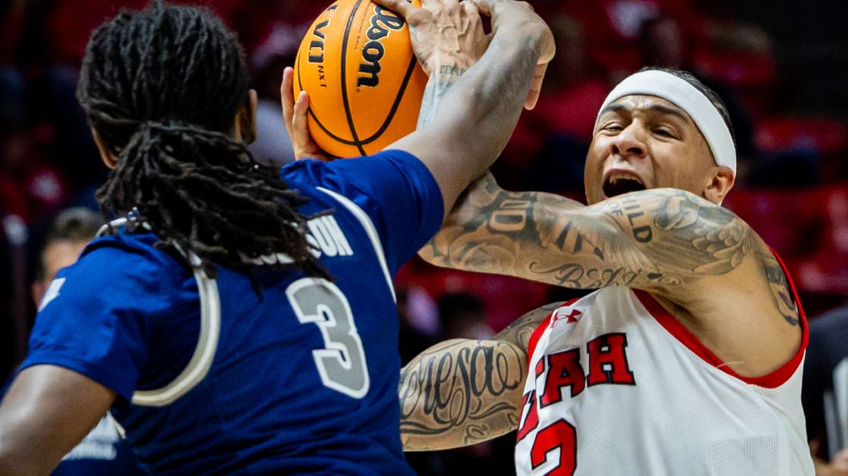 Utah Utes guard Terrence Brown (2) drives the ball to the basket while defended by Nevada Wolf Pack guard Myles Walker (2) during an NCAA men’s basketball exhibition game at the Jon M. Huntsman Center in Salt Lake City on Friday, Oct. 17, 2025.