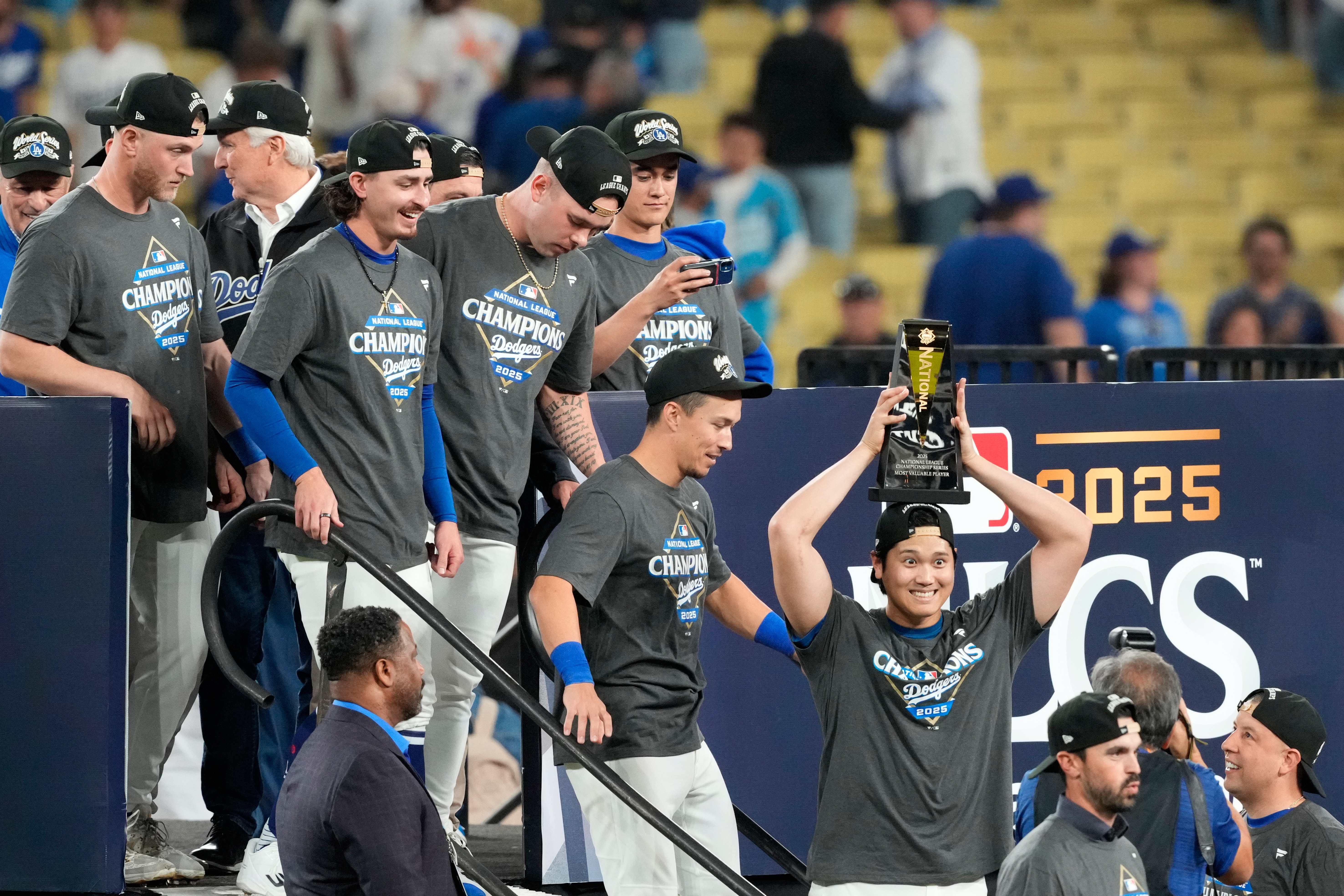 Los Angeles Dodgers' Shohei Ohtani celebrates the the trophy after their win against the Milwaukee Brewers in baseball's National League Championship Series, Friday, Oct. 17, 2025, in Los Angeles.