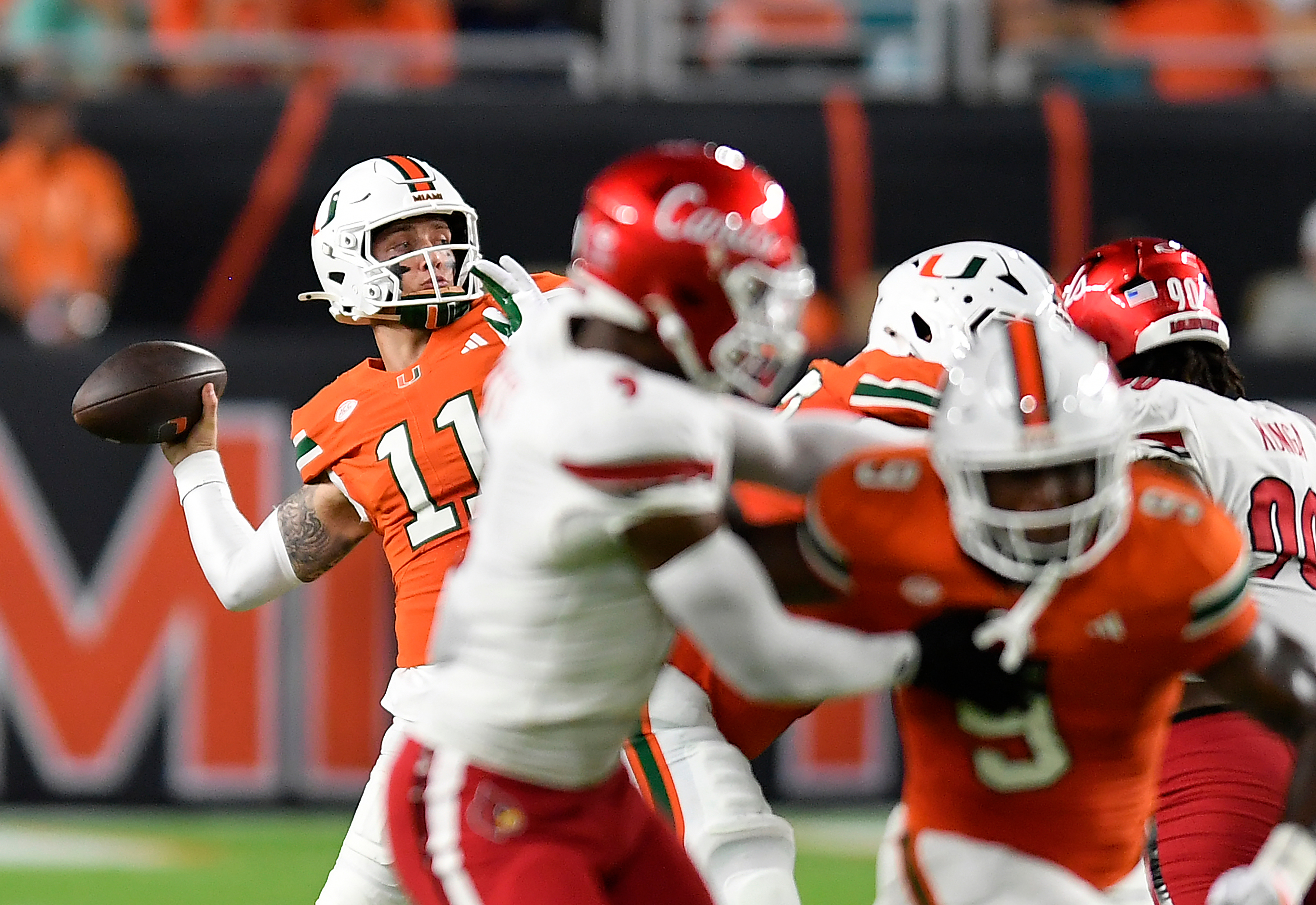 Miami quarterback Carson Beck (11) throws the ball during the first half of an NCAA college football game against Louisville, Friday, Oct. 17, 2025, in Miami Gardens, Fla. 