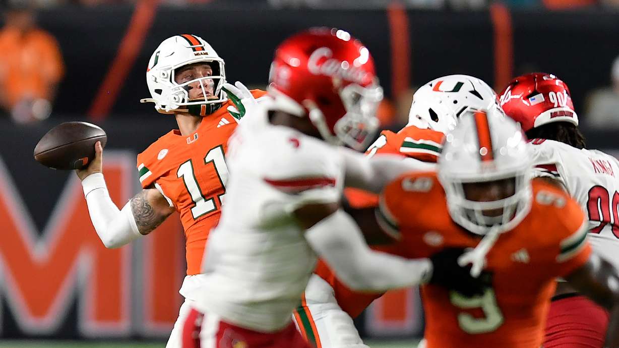 Miami quarterback Carson Beck (11) throws the ball during the first half of an NCAA college football game against Louisville, Friday, Oct. 17, 2025, in Miami Gardens, Fla.