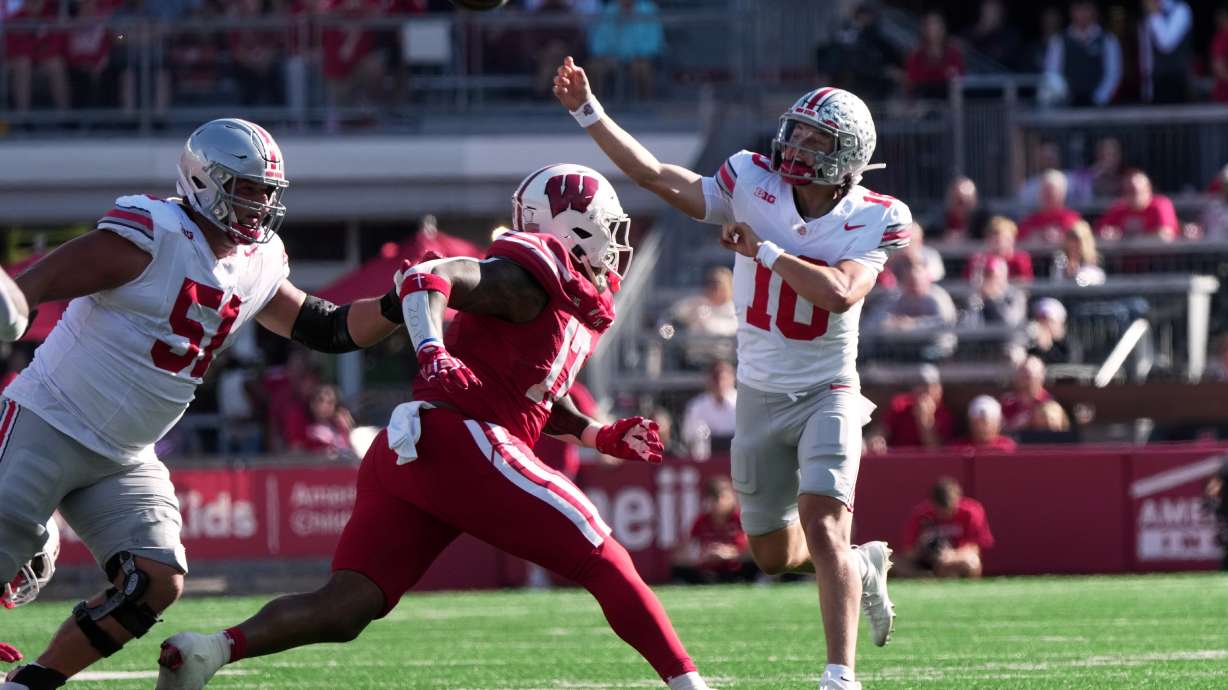 Ohio State's Julian Sayin throws a touchdown pass during the first half of an NCAA college football game against the Wisconsin Saturday, Oct. 18, 2025, in Madison, Wis.